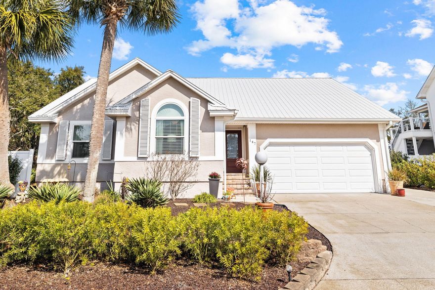 This custom-built residence is located in the private, no-rental, gated Sandcliffs community. Upon entry, the home welcomes you with its open layout, offering open views of the swimming pool from nearly every room, enhancing the sense of space and connection to the outdoor living areas. It features refined architectural details such as bullnose corners, crown molding, and chair rails, complemented by thoughtful built-ins throughout. The living areas seamlessly integrate the kitchen, dining, and living spaces, all oriented towards the screened-in pool and patio through large glass doors, creating an ideal environment for family living or entertaining.