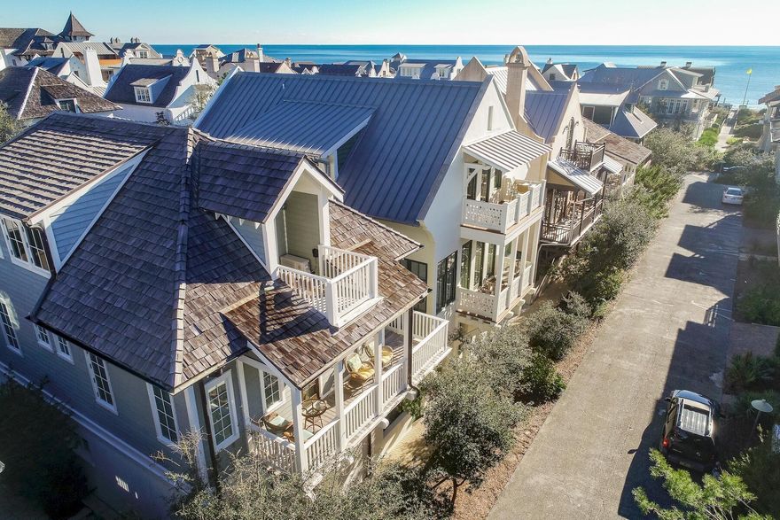 Designed by Michael Piazza, this popular Rosemary Beach cottage is located south of 30a, and close to the beach and village shops. Gulf views can be enjoyed from the 2nd and 3rd floor balconies. The Barbados Pool, one of four private Rosemary pools, is across the street. The beach is an easy one minute walk away. The three story main house offers Viking appliances, hardwood flooring, and wet bar. The first floor features an open living - kitchen floor plan with twelve foot ceilings. An abundance of windows offering natural light and two kitchen islands make this ideal for family gatherings.The second floor includes three en-suite bedrooms plus laundry room. Upon arriving at the third floor, you'll find a kids' delight with seven bunks and two separate bathrooms. The carriage house offers two full levels of living with a full kitchen, built in bunk and king bedroom loft.   
The exterior offers two courtyards, a Viking outdoor grill, two car garage and an outdoor shower. The dutch west indies architecture is complimented with white stucco, cedar siding, cedar shake roof and peacock pavers. This favorite of many returning families for years is now being offered fully furnished and turn key rental ready. 