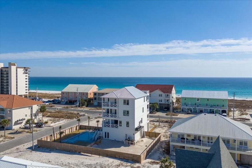 This home is a must for any savvy investor looking to own an entertainment oasis with great ROI potential. Discover the ultimate escape with this magnificent custom built 8-bedroom, 8.5-bathroom vacation rental on peaceful Navarre Beach. Designed to accommodate up to 32 guests, this 4,511 sq ft luxury home offers high-end finishes and comfort. Embrace coastal living with a rare 4th-floor gulf-facing deck that boasts breathtaking views and over 1,100 sq ft of outdoor space, including a large private pool and an outdoor kitchen deck area perfect for gatherings. This expansive 360 degree water view beach home is an excellent investment opportunity. This spacious home with its massive corner lot, offers considerable flexibility. The expansive outdoor area provides a blank slate for future enhancements, with potential for landscaping upgrades, a garden, or recreational spaces such as a pickle ball or tennis courtall appealing to future renters or buyers seeking room to relax or entertain. Step inside to find high ceilings and energy-efficient features throughout, complemented by top-of-the-line appliances and luxury furnishings. This homeowner spared no expense and thought of every detail to make this home the best option on the beach! Almost every room has its own bathroom in-suite. This impressive home also has several master suites with water views. The expansive bunk rooms provide ample sleeping space for everyone. An elevator adds convenience for travelers returning from the beach and are ready to relax. This home already has rental income that will be transferred over to the new owners. 

Just a short stroll will bring you to the white sandy beaches, offering endless relaxation. Stop by the longest pier in Northwest Florida on Navarre Beach. You're so close to Pensacola and Destin, but just far enough to keep the serene and peaceful beaches to yourself. Rated as one of the top beach house locations in the U.S., Navarre Beach is known for its sugar-white sands and sublime national seashores. If you're looking for an exclusive and serene experience, this stunning rental property is the perfect choice. Don't miss your chance to own a piece of paradise in one of Florida's most alluring destinations! Life is short! Buy the beach! With its prime location and luxurious amenities, this home is not just a residence but a lucrative venture waiting to be maximized. Potential owners will appreciate the perfect blend of comfort and opulence that caters to large groups seeking a memorable beach experience. Whether you're considering it for personal use or as an investment, this property promises endless possibilities.