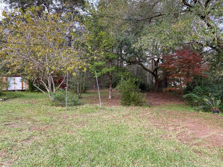 RARE 6.5 ACRES in East Milton with so much potential for the next owner.   With the small home and several storage units on property this acreage has so many options for the next buyer. The property has 3 separate septic tanks and 3 separate water meters.  The land is full of fruit trees, Japanese magnolia's , Wisteria, and so many more beautiful foliage.  Previously there has been more than  one home on the land so electricity has been available in several locations throughout the acreage.  The 3 bedroom 1 bath main home has heating & cooling, a small kitchen as well as a separate laundry area.  Value is in the 6.5 acres!. Don't miss this rare 6.5 acres close to schools, shopping and Pensacola.  Buyer to verify all dimensions*