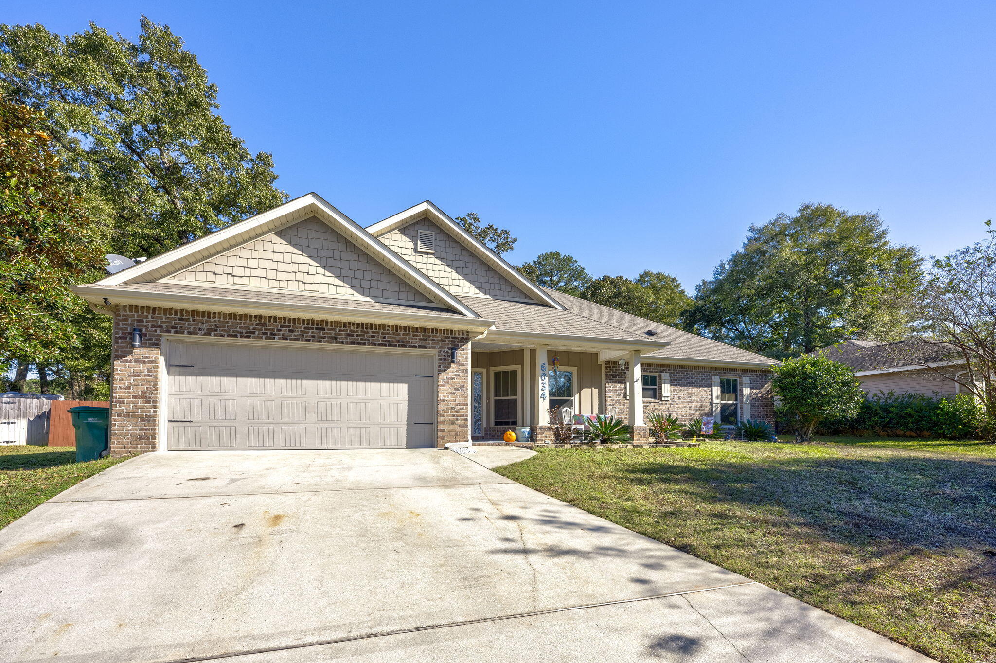 Welcome to Zachary Estates, where this inviting 4-bedroom, 2-bath Charleston floor plan awaits. This well-maintained home blends style and practicality, offering a comfortable living experience.Inside, you'll find tray ceilings with crown molding and rich walnut wood flooring flowing through the main areas, creating a warm and welcoming atmosphere. The kitchen features dark espresso stacked cabinetry, stainless steel appliances, and granite countertops, with tile floors adding a classic touch. The layout is thoughtfully designed for both cooking and entertaining.The master suite is a relaxing retreat, complete with a tray ceiling, walnut wood flooring, and private access to the covered patio. The ensuite bathroom includes dual granite vanities, a garden tub, and a spacious walk-in shower with a built-in seat for added convenience.

Three additional bedrooms are spacious and versatile, while the second bathroom, with its dual vanity, is perfect for shared use. The covered patio is a great space for outdoor relaxation or entertaining, and the fully fenced backyard provides privacy and plenty of room to enjoy.

This home also features a video surveillance system, offering added peace of mind. The exterior boasts classic brick siding and a neatly kept yard, offering plenty of curb appeal. Located in a desirable neighborhood, this home is ready for its next chapter. Schedule your showing today!