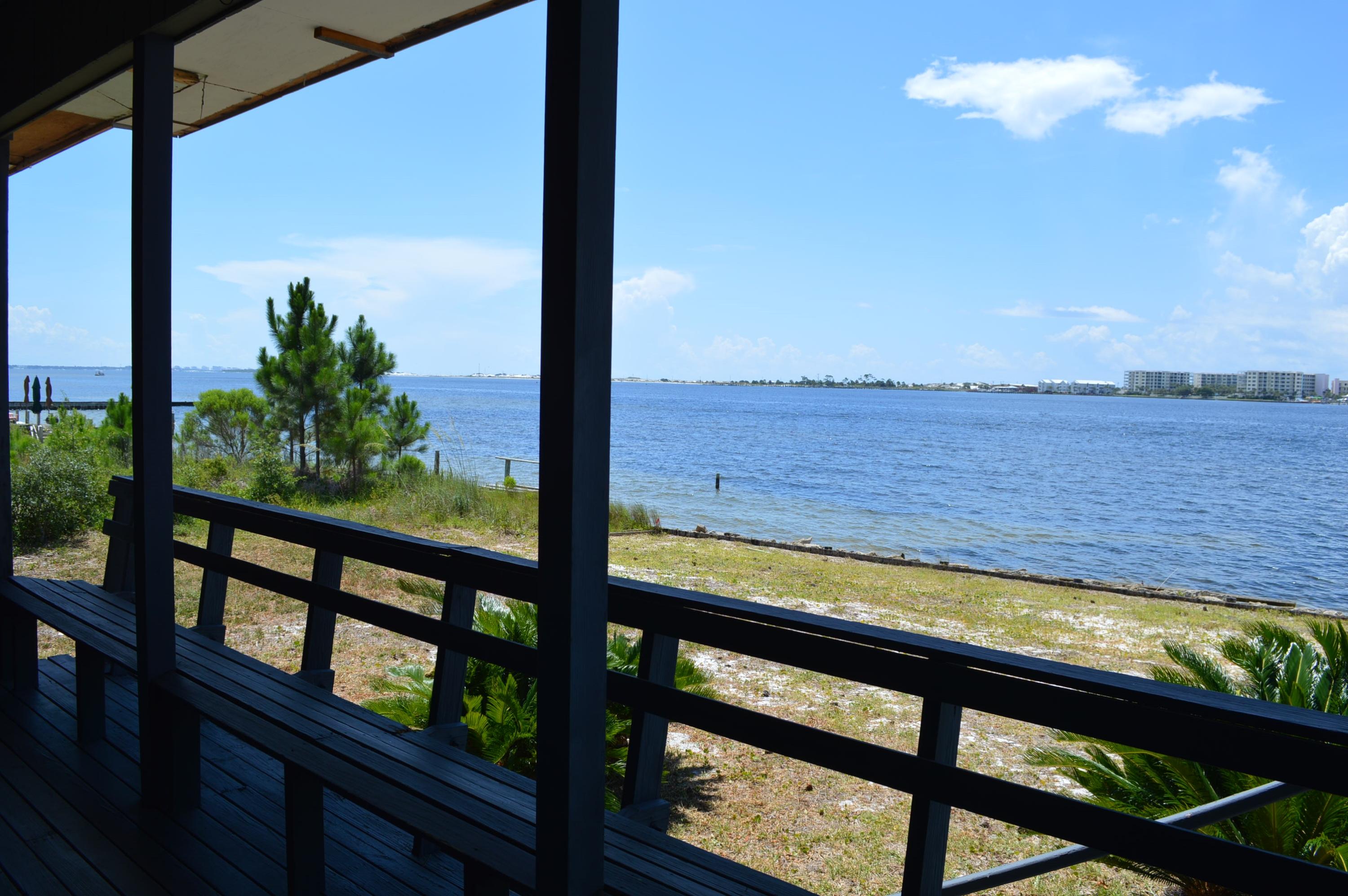 Located in Southside Fort Walton Beach on a peninsula, this is a vintage home well-built, but in need of renovation. This is a water lover's dream home with the vibrant Intracoastal Waterway on the south side and protected, calm waters of a deep-water bayou on the north side. The home has a spacious living room with windows on three sides and a slider that flows out to the deck. The kitchen has an adjoining area that could be for dining or recreation. A kitchen island separates the two areas. A wall of windows exits to the covered deck. You will find two master suites, one downstairs with ceiling to floor windows and another on the second floor. Both have private baths. Another bedroom and a loft that could be bedroom or office is also upstairs. New interior AC in 2012