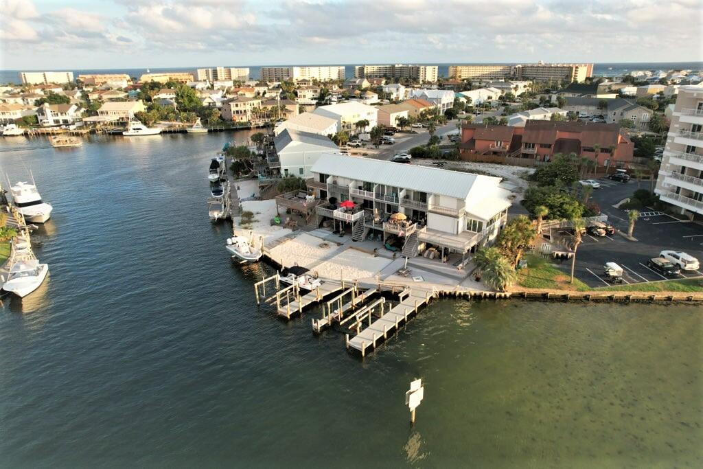 Rare Opportunity, Harbor Front Boaters Paradise with a Dream View! LOW Dues! 2 Boat Slips! This end unit 3 Story Townhome offers Superior Visibility across the Destin Harbor. Enjoy Spectacular Sunsets, Fireworks, Boat Parades and More without ever leaving your back deck! That's Not even the best of what this Waterfront Home has to offer, Fish from your backyard, jump on your boat and you are at the Pass, Gulf of Mexico and Crab Island in 5 minutes! Lots of Storage Space as well! No expense spared on the Exterior everything has been meticulously redone with Azek decking extending from the bottom level out to the docks, Flow Through decking & Vinyl Seawall in Great Shape. Beautifully Landscaped and newer Siding and Paint! Aluminum Handrails around all balconies with zero maintenance!