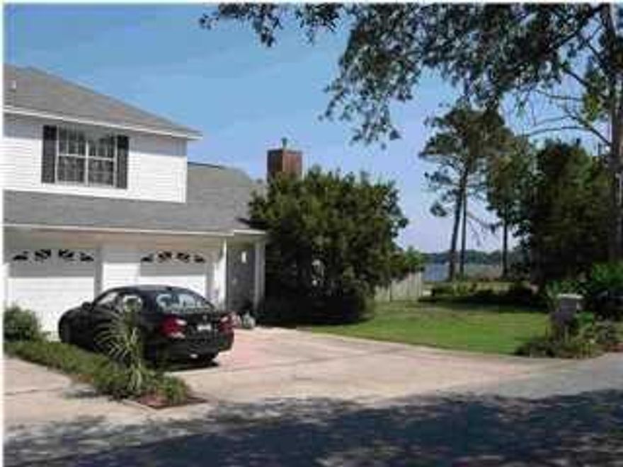 Welcome to your Vale of Paradise. Looking for a property close to the water? Affordability? No HOA too! The community of Valparaiso Village built by Randy Wise Homes is for you. Just imagine being minutes from Eglin Air Force Base -so coming home for lunch is a reality. Lincoln Park on Boggy Bayou is just a couple of blocks away so you can the enjoy water sports, picnic, or simply relaxing. You also have a water view from the backyard and the master bedroom. The home has oak flooring throughout so no carpet to worry about allergies or stains. Tile in all the wet areas. Though the master bedroom is upstairs there is a guest bedroom and bathroom on the first floor. Kitchen with breakfast bar, pantry, and all the appliances convey at closing. Home warranty provided for one year to new owner. The living room has a gas fireplace for the cool Florida evenings. Plenty of windows for natural lighting.  The dining room is great size so no issues with a sideboard or hutch.  The French doors lead to the porch with an arbor and trellis that provides natural shade. Taking the oak staircase up to the landing it features 2 bedrooms with one on each side.  The master is on the back side of the home with a door leading to a small deck for sipping your coffee or tea in the morning or just taking in the view.  A large walk-in closet in master bedroom.  The master en-suite has a separate shower and a whirlpool tub.  The double vanity with cultured marble top has plenty of storage.  The walk-in laundry closet is upstairs in the hallway and provides additional storage.  The front bedroom with in suite bathroom and a great storage closet too!  The bedroom also has walkout access to the attic. A full 2 car garage with separate openers.  The back yard has a privacy fence and a small shed. The HVAC was replaced in 2013.