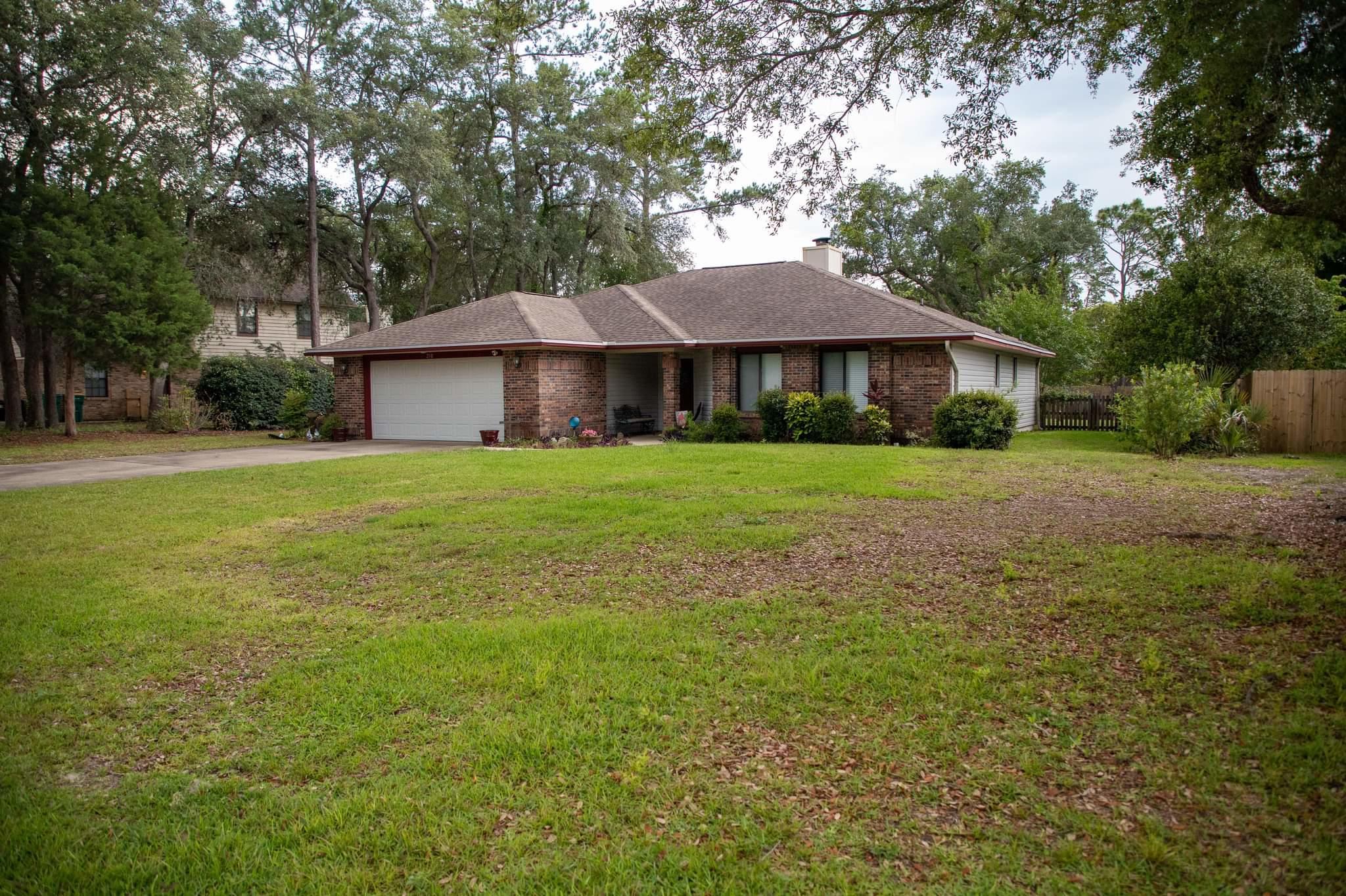 Don't miss out on this 3bd/2ba home featuring a Florida Room that is Heated & Cooled! Turn this additional living space into your office, play room, or another living area. Walk through the living room into a beautiful dining area that overlooks the back patio. This home also includes a fireplace and custom built shelving in the living room. Each bedroom has a full walk in closet! You will enjoy direct access through the master bedroom to a freshly painted pergola overlooking the back yard with room for a trampoline or other outdoor activities. There is a well pump for the irrigation system. Vinyl siding was replaced in 2019 but looks brand new. One owner well maintained home. Located in Bluewater Bay just minutes from Destin!