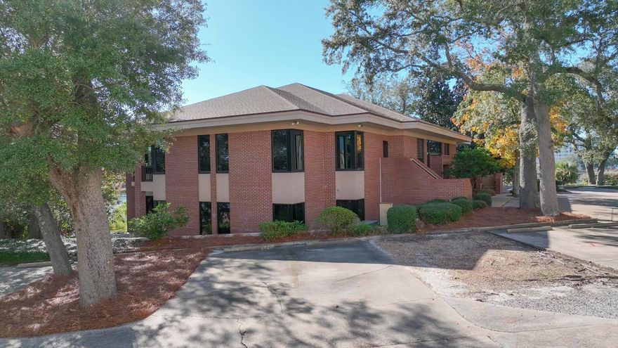 The Barron & Redding Law Office is available for sale. One of the most prestigious Class ''A'' law office buildings in Panama City. Located adjacent to the Bay County Courthouse on Massalina Bayou which leads directly to St. Andrew Bay and the Gulf of America. The 10,157 square foot, two-story office building is situated on 1.1 acres. Masonry construction with brick veneer and huge windows throughout. The entire office has extensive wood moldings, paneling, and trim, particularly in the attorney's offices, conference rooms, and law library. The two-story office includes 18 large private offices, 2 conference rooms, a law library, open office for paralegals and administration, workspace, large breakroom, and reception. Built in 1986 and renovated in 2019 following Hurricane Michael. The  well-constructed building received minor damage from the Hurricane. The following renovations were completed: all new storm-rated impact windows and doors, new roof, new HVAC systems, and new flooring. There is +/-550 linear waterfront feet on Massalina Bayou with a submerged land lease in-place that provides for the deep-water dock space with a large pier and wooden dock capable of accommodating several large boats. Gorgeous views across Massalina Bayou. The Bay County Courthouse is less than 300' up McKenzie Avenue. Beautiful landscaping with mature oak trees all over the property. The location cannot be matched, and they truly do not make them like this anymore. The site plan, elevations, and floor plans are attached. Call for further details and to schedule a tour. Barron & Redding is merging with Hand Arendall.