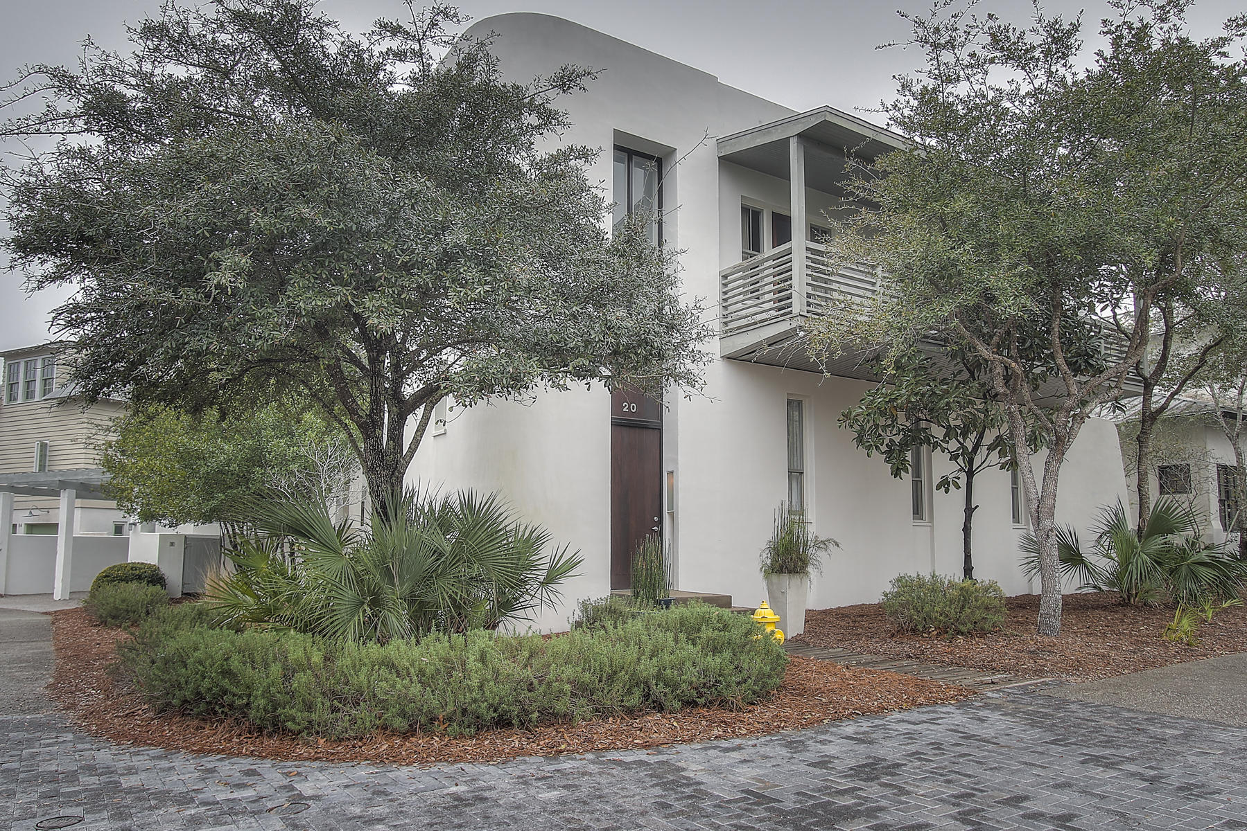 CONCRETE home on LARGE CORNER LOT in ROSEMARY BEACH! This modern home features unique dcor, ABUNDANT NATURAL LIGHT, large 2nd level balcony & plenty of outdoor space. The living area NANO DOORS EXTEND THE LIVING AREA TO THE COVERED PATIO and large PRIVACY FENCED YARD WOTH AMPLE ROOM TO ADD A POOL & CARRIAGE HOUSE! All bedrooms are on the 2nd floor while the 1st floor is built for entertaining. Enter through the 2 story foyer filled with natural light opening to the living & dining area. Plush, oversized seating welcomes you to the relaxing living area w/ sliding Nano doors to seamlessly blend indoor/outdoor spaces. The dining area with seating for 8 sits just off the stylish kitchen w/ Jenn-air appliances. With BUILT IN FRIDGE, DOUBLE OVENS, GAS RANGE & AMPLE HIDDEN STORAGE the kitchen