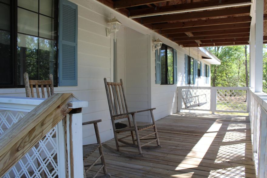 This is a must see property to appreciate. Peaceful and quite, surrounded by trees for privacy. Detached garage with large covered area. The wood frame home features a 3/2 split bedroom floor plan, wood burning fireplace, metal roof.All measurements are estimates and should be verified by buyer.