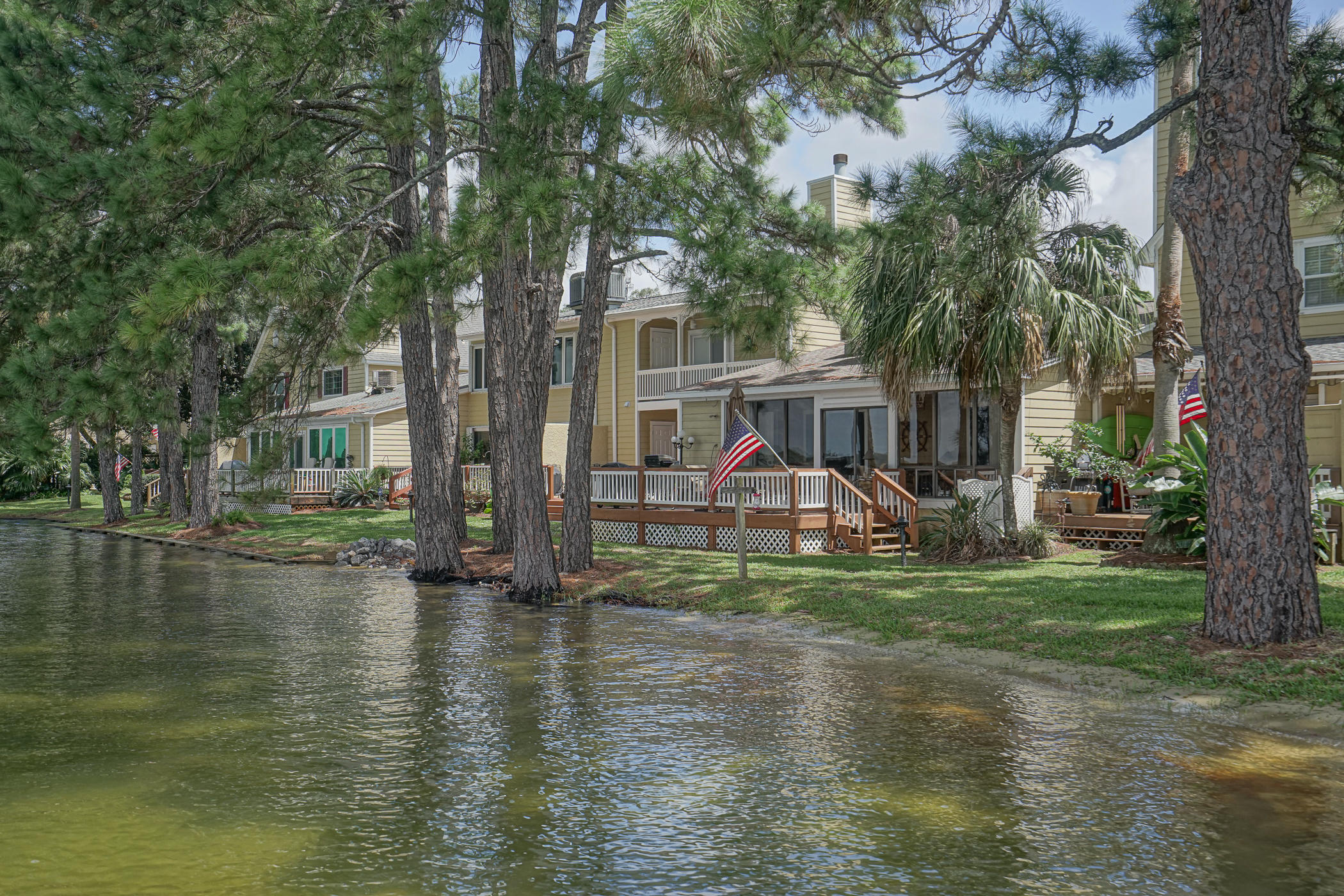 Stunning views and gorgeous remodel make this a very desirable home on Garnier Bayou. You'll be impressed from the moment you enter. Seller has spared no expense, everything has been updated. Boat slip with lift is right out your back door to enjoy the waterfront lifestyle. Living room has a fireplace and opens to 18 x 24 deck, great for entertaining. Kitchen features beautiful seeded glass front, lighted cabinets; granite counters; stainless backsplash; stainless appliances and breakfast bar. Easy care, wood look tile downstairs and matching LVP upstairs. Great view from waterfront master with fantastic adjoining bath. Relax on the large balcony and enjoy your morning coffee. Super guest bath with large walk in shower. Very cheerful with natural light throughout. Don't miss this one.