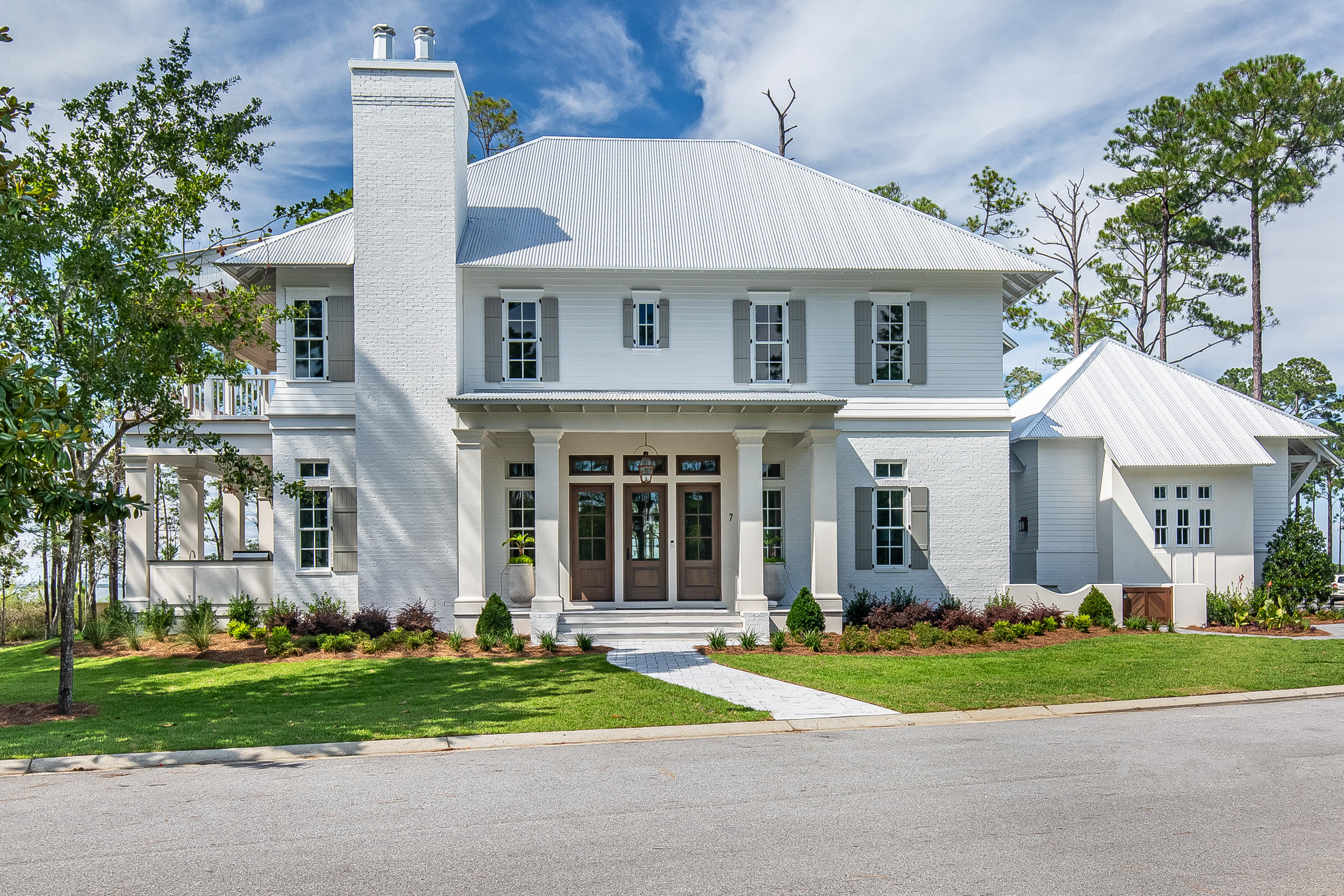Completed in Summer 2019 in the Churchill Oaks neighborhood, this stunning home offers 4 bedrooms with one on the main level, 4 and 1 half bathrooms, a 2-car garage and extraordinary finishes such as wire-brushed oak floors, tongue-and-groove ceiling and brick accents throughout. Enjoy quiet evenings on the wide covered porch with gorgeous views of the Bay. The spacious first floor features two sitting areas with one centered around a white brick fireplace and grand dining room with a striking designer chandelier. The chef's kitchen faces the living area with beautiful quartzite counters, shaker style cabinets, a white brick accent wall, Wolf appliances including 48'' 6-burner range and Sub-Zero appliance including side-by-side refrigerator, wine cooler, and ice maker.