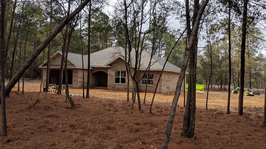 Beautiful New construction All brick home sitting a large 1.18 acre lot that has front and side access to the property. Huge 30 ft cover back porch with view that has plenty of room for a future shop or swimming pool! Open concept home with 4 bedrooms and two full baths. Front bedroom on plans is labeled as a study/office, but has a closet, so you choose how you want to use it. Beautiful Kitchen has granite counters and well as all stainless appliances that includes a refrigerator. Nine foot ceilings with crown molding in Family room and Master Bedroom with Trayed Ceilings. Still time to choose your colors and flooring if you hurry! Brand New Dollar General Store within a couple of miles just opened that's going to great for the area! Come out and see our progress today