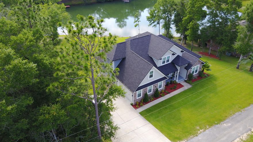 BEAUTIFUL LAKEFRONT 4544 sqft 6 bd 4 bath CUSTOM HOME with FULL BASEMENT features Quality construction on a 1 acre lot! This home is practically new and was designed to WOW! The open floor plan offering expansive lake views, features modern clean lines, high end finishes, massive windows, custom Aluminum stair railing, designer led lighting, upgraded media wiring, spray foam insulation, a living room with 19ft ceiling and electric fireplace (with heater/blower), large kitchen with custom cabinetry, granite counter tops, stainless steel appliances and breakfast bar. The master bedroom overlooks the lake and has a private balcony! Just off the master is a second 1st floor bedroom which is perfect for a nursery or executive office. The basement features a large bedroom, bathroom, kitchenette,