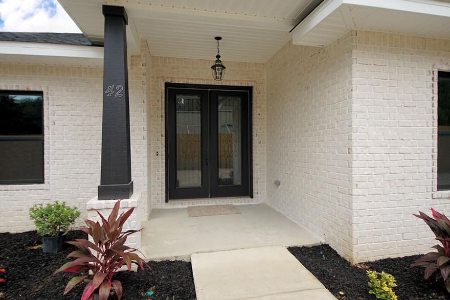 New Construction on over a 1/3rd acre lot in Poquito Bayou by Barber Custom Builders. Your foyer welcomes you as you enter your front door and the open concept floor plan invites you to stay. Office is on right. Proceed forward to a dining area on right open to your living room and kitchen. Kitchen has Carrara quartz counters and white shaker cabinetry. Counter top is pictured in photos. Tile back splash and soft close cabinets. 4 pendant lights will hang over your large island with lots of prep space for the chef and entertaining space for the host. Wood style tile throughout living spaces (pictured in photos), carpet in bedrooms. Master bath has separate soaker tub, tiled shower, walk-in closet and double vanities. Privacy fence in backyard. 2-10 bonded builder warranty.