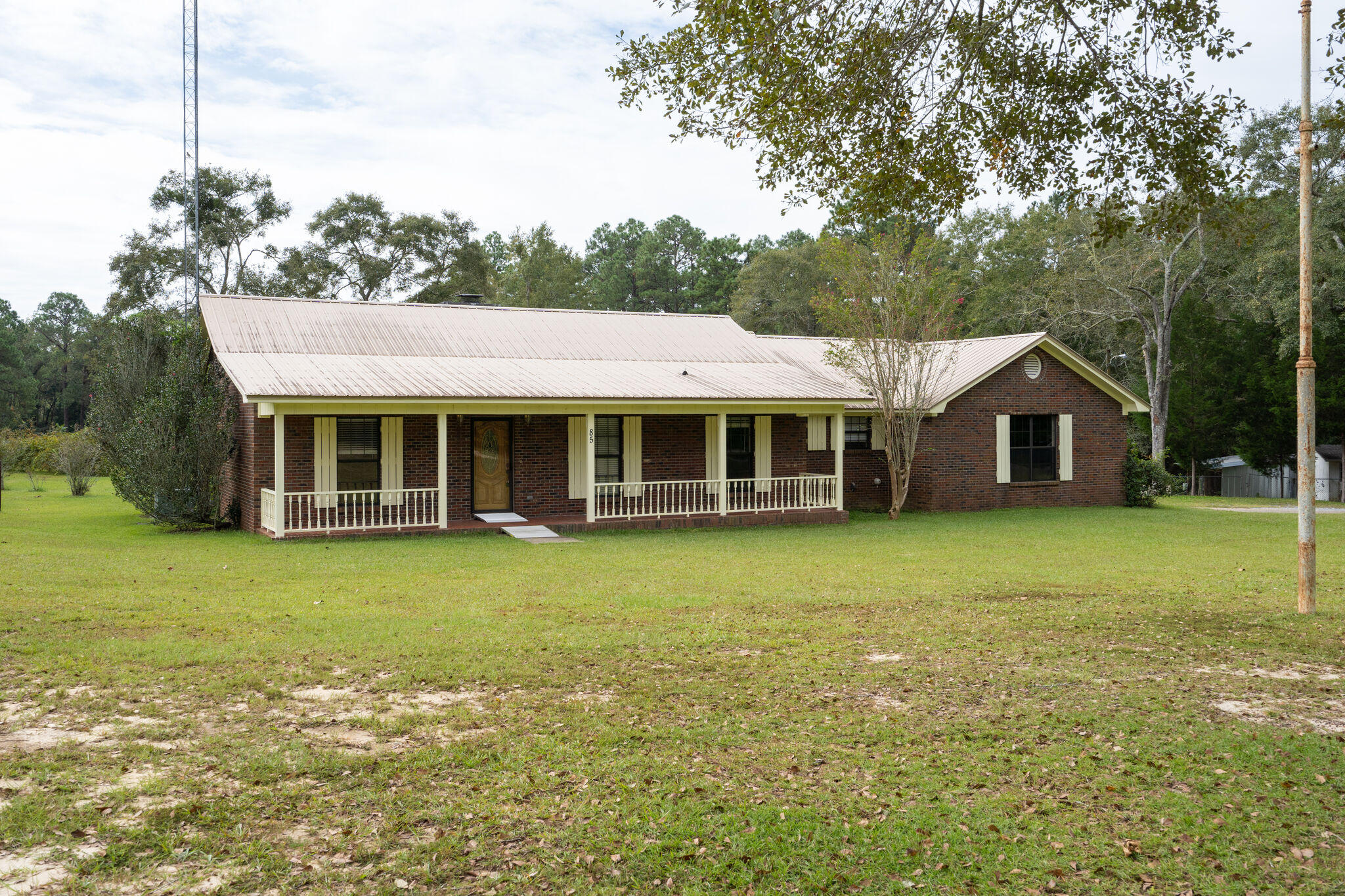 Home sweet home! This property is nearly 4 manicured acres that the current owner has lovingly worked into a fruit orchard. Here you have more than 30 blueberry bushes, several persimmon trees, fig trees, pecan trees, and various citrus trees. Be sure and check out the fully equipped workshop (12x20) that features rollup door and electrical service. Moving on to the home, you will find that it is virtually maintenance-free with its brick exterior and durable metal roof. Once inside, you will notice how meticulously it has been maintained. The open floor plan that makes this home perfect for entertaining. The kitchen is sure to please the chef in the family with an abundance of counter space for meal preparation. The master suite is quite large and sits at the rear of the home giving it