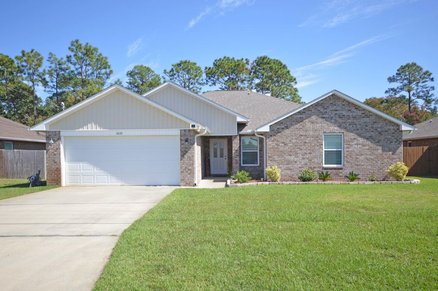 Welcome home to this fantastic 4 bedroom home located in Navarre close to schools, beaches and shopping! All brick home boast a large  spacious living/family room with high ceilings and plant ledges! The kitchen is open and perfect for entertaining with a breakfast nook adjoining! The large kitchen has beautiful custom cabinets, tile floors, smooth top stove, upgraded faucets plus stainless steel appliances! The split floor plan has 3 additional bedrooms on another wing for privacy and quiet!  Master bedroom has a trey ceiling and double windows looking out to the peaceful privacy fenced backyard with Extra Large Patio; Master bath has his and hers walk in closets and a garden tub with separate shower; Tile floors; The master bath has double vanities for privacy and convenience; Additional