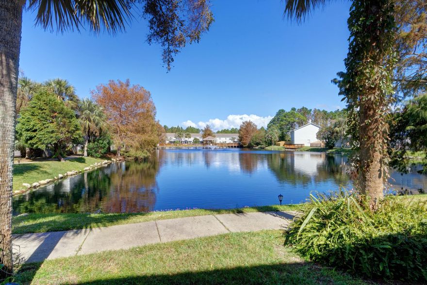 Welcome to this lovely waterfront townhome in the highly sought after Tiger Lake Subdivision! This move in ready beauty features 3 bedrooms (with a downstairs master bedroom), 2.5 baths plus a loft which features custom built-ins. Pull up to the property and enjoy parking on the two car driveway (rare for the neighborhood!), appreciate the extra safety measure of a camera doorbell, and upon entering the home you are greeted with large 18in tile flooring which extends throughout the bottom floor common area below the soaring ceilings. The living room is spacious with recessed lighting, a built in bookcase, updated lighting, and a large sliding glass door where you'll enjoy the stunning water view of the community lake and fountains. The great room is open to the kitchen where you'll find
