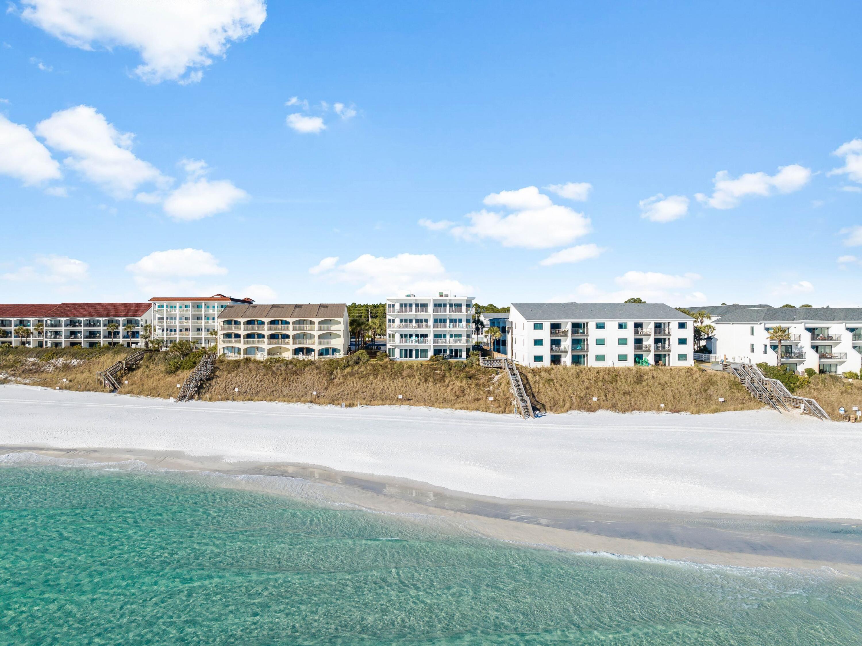 Perched atop a bluff in the heart of Seagrove Beach, this exquisite west-facing condo offers breathtaking, unobstructed views of the Gulf of Mexico -- where every evening ends with a mesmerizing sunset. Located in exclusive Sago Sands, a low-density building with just eight units, this residence provides a rare level of privacy and tranquility.  With only two units per floor, this thoughtfully designed condo features a wraparound balcony, inviting you to savor panoramic coastal views. Inside, tile flooring throughout the living areas ensures effortless maintenance, while carpeted bedrooms add a cozy touch. The private beach walkover with beachside showers and a community pool enhances the experience of effortless beachfront living. Additional conveniences include an elevator for easy access and two assigned, numbered parking spaces. Whether you're looking for a tranquil retreat or a savvy investment, this rare gulf-front residence delivers an unbeatable combination of privacy, luxury and coastal convenience.