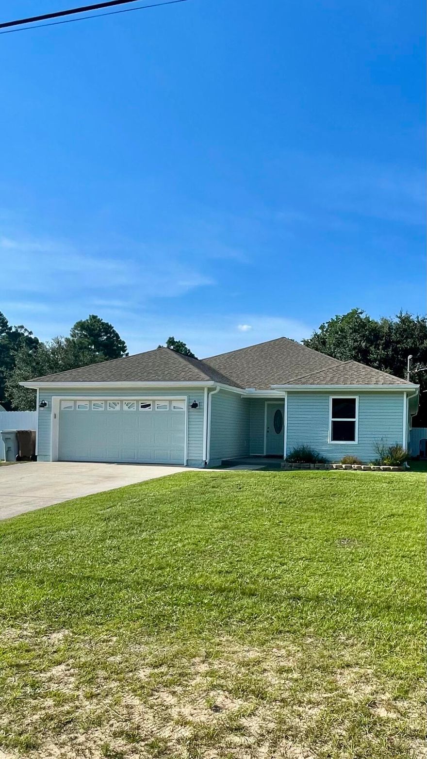 Look for the Grey Door! Light and bright!  New paint on the exterior and interior! New flooring, new hurricane windows and doors, new countertops in the kitchen and  remodeled baths! New Blinds! . The master bedroom  has new flooring, window and exterior door and the master bath has a large new tile shower, new vanity with sink and a large walk-in closet. The guest bedrooms are split and have new flooring and windows. The guest bathroom also has a new vanity and a large tile shower. The Kitchen offers freshly painted cabinets, new countertops  and white appliances including the refrigerator. There is also a washer and dryer.  The home offers a large fenced back yard and a covered patio with new flooring. The home has a two car garage with a storage cabinet. Great location in West Navarre.
