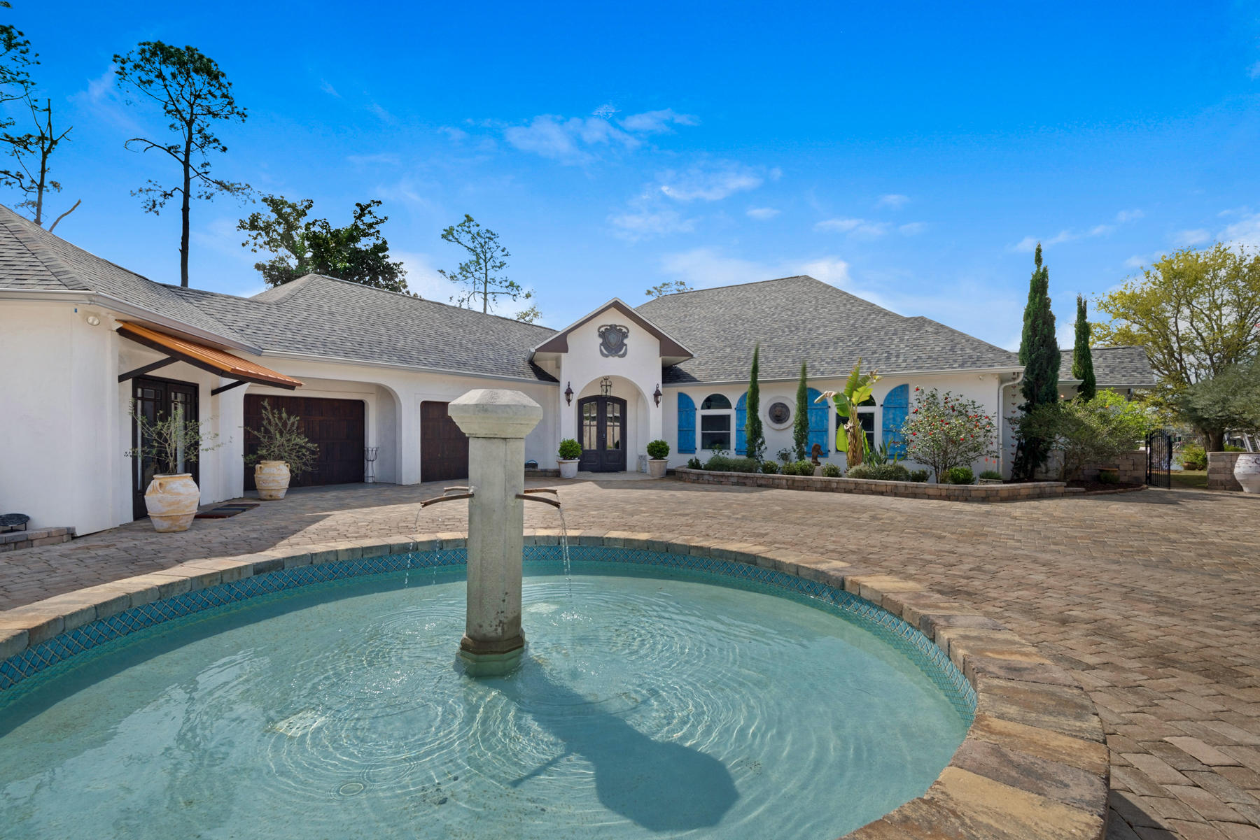 Exquisite estate home, over one acre on the Grand Lagoon. Main home offers 4 or 5 bedrooms all en-suite and an additional office suite. High ceilings, open floor plan, Venetian plaster...There is also a separate 600 SF yoga studio/gym not included in SF. Swimming pool, boat dock...