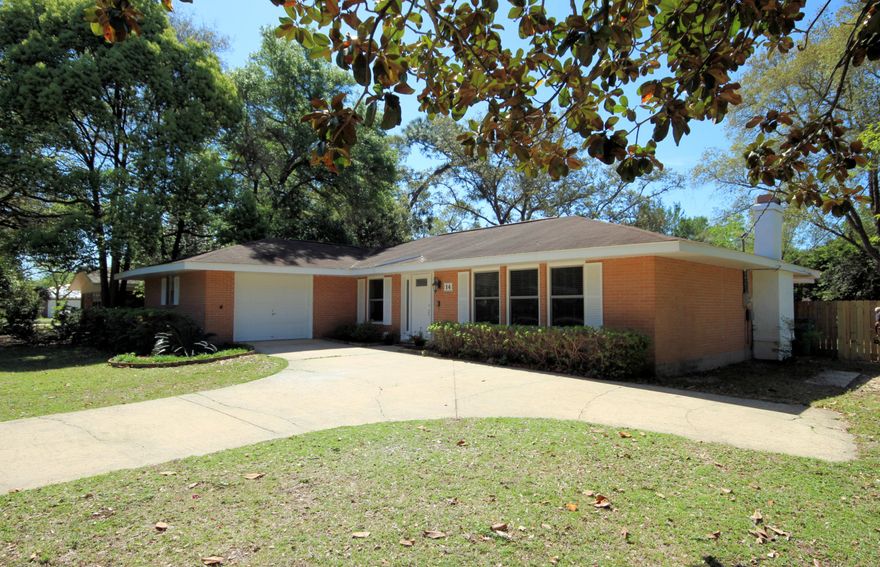 Turnkey and Pristine brick (3) bedroom home in Bayou Poquito. Sellers have added beautiful laminate wood flooring throughout Kitchen, Family and Living/Dining area, and carpet in bedrooms. The Dining/Living area features a wood burning fireplace and built in bookshelves. Fresh paint and a brand new front door flanked by glass panels welcome you. Enjoy cool breezes on the large screened patio (12' X 48') that runs the entire length of the home and accessed from (3) sets of sliding doors in Master bedroom and family room. Privacy fenced shaded back yard with pretty Camellias and handy shed. Enjoy nearby park, playground, and boat launch. Home only minutes from Eglin Air Force Base. Newer A/C unit in this well maintained home. Plenty of storage. Homes in this neighborhood sell quickly!
