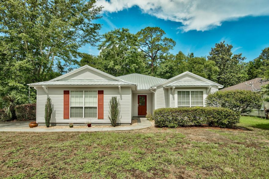 This charming 3 bedroom, 2 bath home is in the ideal location being just minutes from a beach access and many local favorite restaurants and shopping! Perfectly situated in the quaint gated community of Magnolia Creek, this home invites you in with great curb appeal and a wonderful split floor plan. Upon entry, the Australian Cypress wood floors capture your full attention and are carried throughout the spacious living area, separate dining area, and bedrooms. The heart of the living room is the wood burning fireplace, a perfect place to cozy up on cold evenings! The updated kitchen features solid wood cabinetry, tiled backsplash, granite counter tops, and stainless steel appliances. Next to the kitchen is a breakfast nook perfect for enjoying your morning coffee. The guest bathroom has