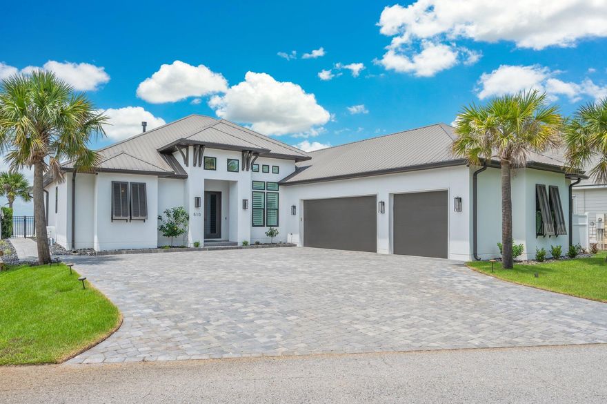 BAYFRONT LUXURY LIVING - PRIVATE DOCK, POOL, AND PANORAMIC VIEWS! Experience the ultimate in upscale coastal living with this custom-built Bayfront masterpiece, thoughtfully designed to capture sweeping water views from nearly every room. This stunning home offers a seamless blend of refined indoor comfort and exceptional outdoor living. The gourmet kitchen is a showstopper, featuring a large island, and quality SS appliances. Outside, paradise awaits. Enjoy a private boat dock with lift, jet ski lift, and swim platform - ideal for fishing, dolphin watching, or sunset cruises from your backyard. The covered patio, outdoor fireplace & summer kitchen overlooks a sparkling private pool & tranquil water fountain! Oversized 3-car garage, and amazing location!  Waterfront living at it's finest! This prinstine property comes with a tremendous amount of additional upgrades, such as: 
a 27kw Generac whole house generator installed in 2024, New AC's installed in April '2024 as well as a tankless hot water heater and an outdoor rust removal water system for irrigation. This property includes everything a meticulous buyer could ask for. 