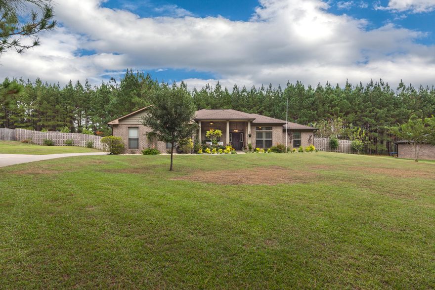 Delightful country oasis in a community known for grand homes and HUGE 1 acre lots! This home is sure to wow, delivering on tons of usable space both inside & out. Floorplan offers up 4 generous sized bedrooms, in addition to living room, formal office/dining room, and kitchen w/eat in space. Center working island & extra countertops provide plenty of storage space, with additional seating available at the island or countertop bar. The FLAT backyard is a showpiece, with 1 private acre that is fully fenced (tree lined @ rear) for your enjoyment. Enlarged covered back patio has enough space for seating and hot tub. Producing peach tree, blueberry/blackberry/raspberry bushes add a sweet touch to this property. Be sure to note: enlarged parking area, exterior lighting, surveillance system