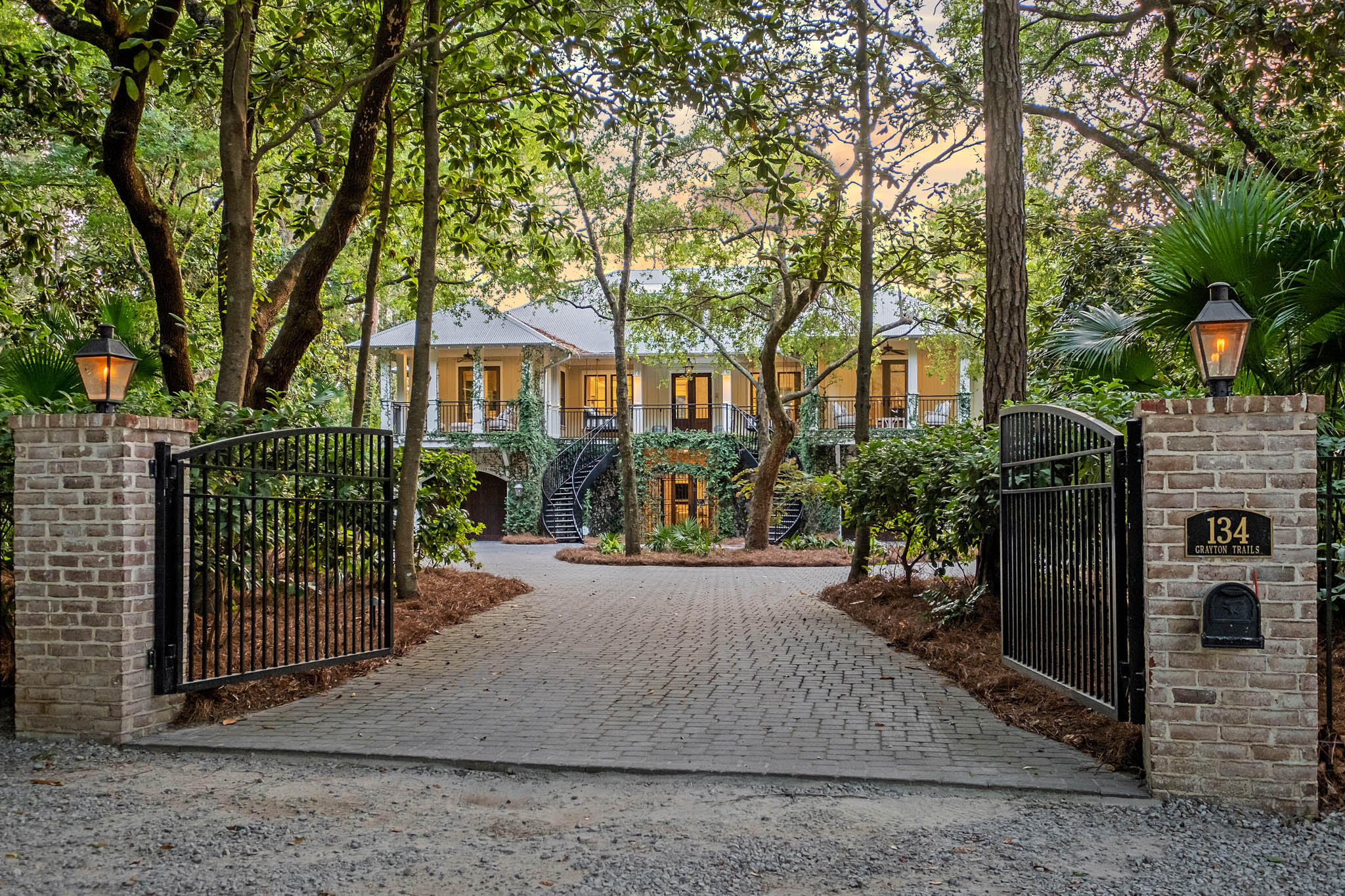 Nestled on a private road in the heart of Grayton Beach, 134 Grayton Trails is a stunning residence that exemplifies contemporary elegance and classic design. The neighborhood offers overarching mature century-old oaks, shady magnolias, and towering pines, creating a dense canopy and arguably one of the most serene settings on all of Scenic Highway 30A.Completely renovated by the talented team at Envision Builders Group in 2021, this home encompasses over 5,600 sq ft of heated and cooled living space, including 6 bedrooms, 5.5 bathrooms, a bunk room, and a sleeping porch.Upon entering the gates, you are greeted by a winding double staircase providing a grand entry to the main level of the home. This level combines kitchen, living and dining spaces ideally for hosting