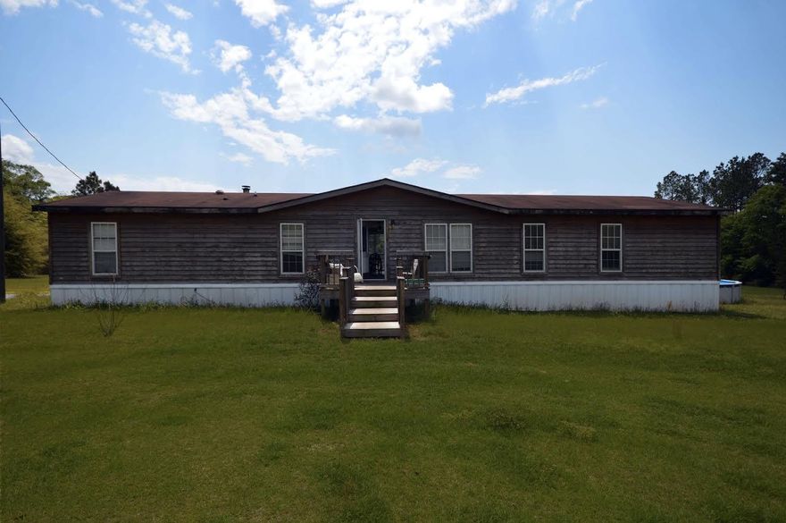 Own your own peice of Pardise. Beautiful home located on 10 acres in north Baker,4 bedroom 2 bath with a beahtiful above ground pool, large wooded deck leads to pool, wood detached storage with hang over for parking. Water piped to shed and garden area.Don't miss your opportunity to see this beautiful home.