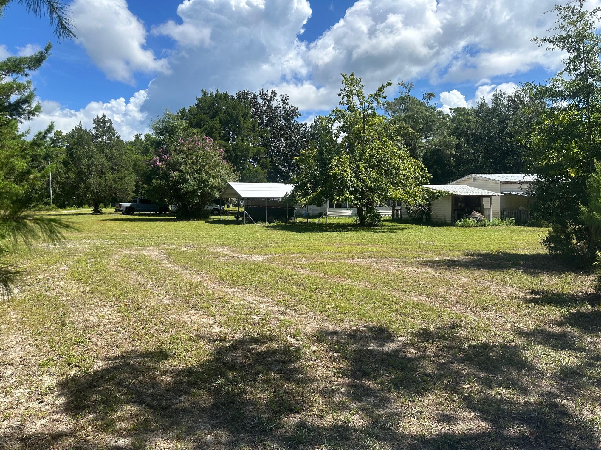 Own your piece of paradise on this majestic parcel of over 1 acre of land. Remodel or remove the existing home & build new, this property has multiple options for use. The landing for bay access is 800 yards away! This low density neighborhood could be yours for easy living old Florida style.