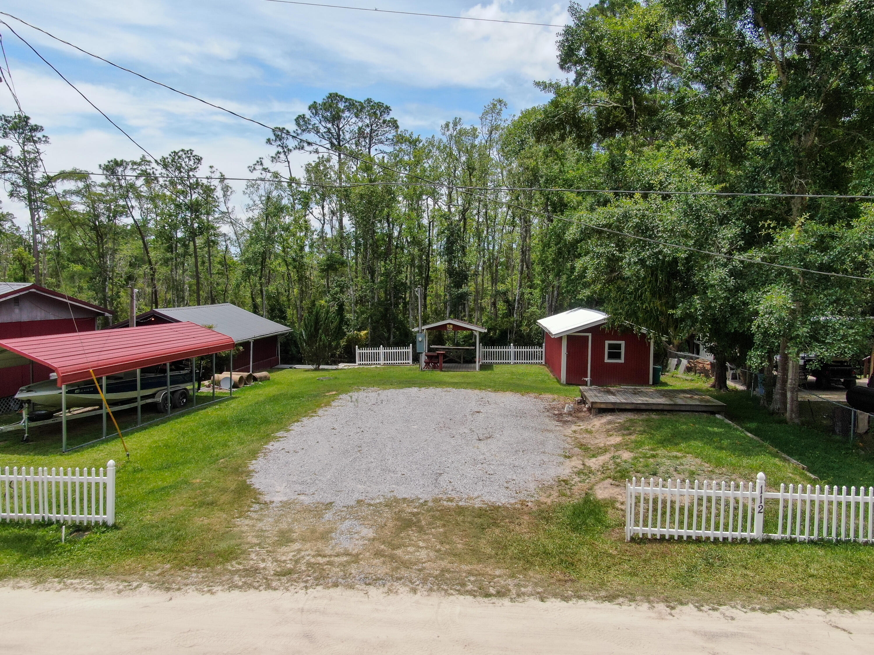 This is a unique opportunity to own a canal front lot in Black Creek Community. The lot boasts 60' of water frontage with quick access to the main river 350' Feet away. Jump on your boat and enjoy a day of fishing, or head South and hit the bay or the intercostal waterway. When you return, pull into your private boat house, secure your gear, clean your catch, and take in all that nature offers. The lot is small and ready for an RV or a tiny house. It has septic, power, city water, a seawall with a deck, and a gazebo. The infrastructure is here. All you need to do is decide how to make it yours. This lot is a 15-minute drive to South Walton, 10 minutes to the City of Freeport, and two freshwater and two saltwater launches within 10 minutes.