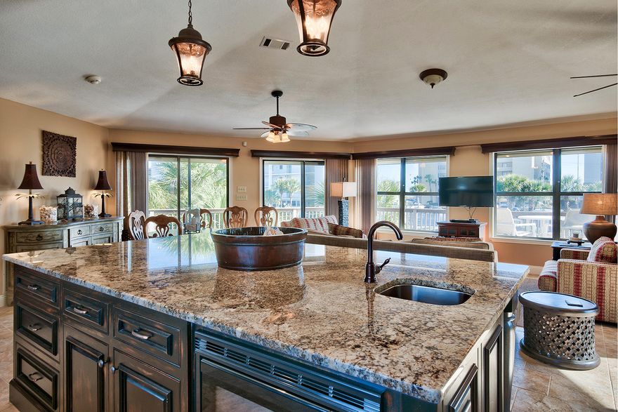 Check out this incredible beach house ideally situated on Okaloosa Island with beautiful Gulf views and easy access to the Santa Rosa Sound. This home has been extensively remodeled both inside and out with plush interior finishes including custom cabinetry in the kitchen & baths, an ample sized kitchen featuring gorgeous granite countertops as well as a generous sized 8x11 center island complete with a single slab granite top and plenty of additional cabinet space for storage. This floorpan is extremely open, with the living room flowing freely into the kitchen and featuring a wall of windows for maximum natural light as well as capturing the stunning views of the white sand beaches & emerald green waters of the Gulf of Mexico.