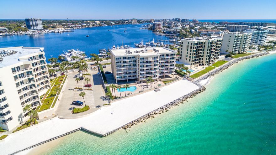 Must see - completely remodeled 3BR unit in gated low rise waterfront complex on Holiday Isle under $450,000! Spacious split floor plan tastefully furnished and decorated with coastal flair features stainless appliances, beautiful jewel toned subway tile backsplash, white quartz counters in kitchen and bath, updated faucets, light fixtures, ceiling fans and much more! Expansive balcony the entire length of the unit is the perfect spot to enjoy the peaceful serenity of sea breezes and harbor lights with friends and family. Tennis enthusiasts will love the direct access to the tennis courts. Great location near Norriego Point on the Destin Pass with views of the Destin Harbor and a short walk to the O'Steen public beach access. Views of the Destin Pass from both guest bedrooms.