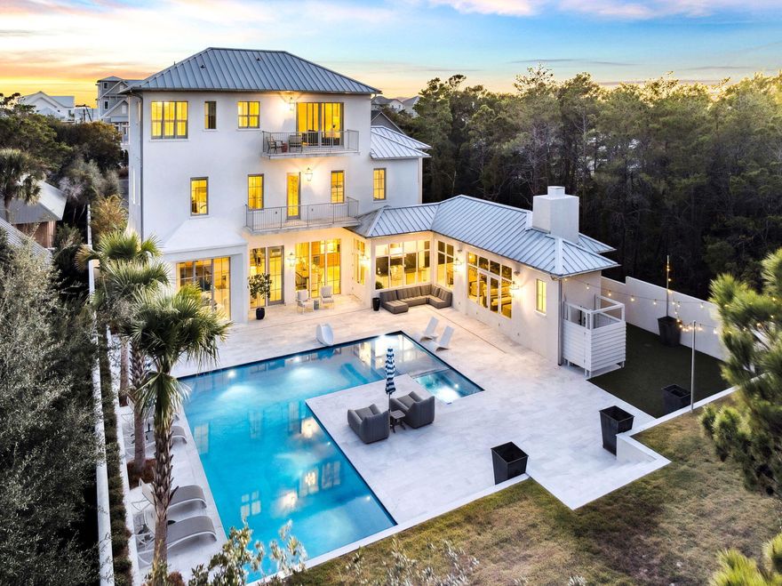 Situated in one of Inlet Beach's premier locations adjacent to Rosemary Beach, this newly constructed residence exemplifies sophisticated architecture and unmatched craftsmanship. Designed by Darrell Russell of A Boheme Design and built by Jared Smartt of Earthbuild Construction, the home spans three levels of refined living on a private, walled, and gated homesite.Constructed to the highest standards, the property features solid concrete construction, a standing seam Galvalume roof, clad impact-rated windows and doors, and coastal-grade gutter systems engineered for durability and minimal maintenance. The climate-controlled two-car garage offers 14.5-foot ceilings, providing ideal clearance for a future vehicle lift.  Inside, Diana Royale marble flooring anchors the primary living spaces, complemented by Venetian plaster walls, a groin-vaulted foyer ceiling, and exposed beam details. The expansive great room serves as the heart of the home, flowing seamlessly to the dining area, chef's kitchen, and outdoor living spaces. Just off the great room, a private loungethoughtfully designed as an intimate bourbon roomprovides a refined retreat tailored to the sophisticated gentleman of the family.

The chef's kitchen showcases Borghini marble surfaces and is equipped with a 48-inch Wolf dual-fuel range, Sub-Zero refrigeration columns, and a built-in Miele coffee system.

The owner's retreat occupies its own private levelan exclusive sanctuary offering Gulf of Mexico views, a luxurious bath clad in Calacatta Gold marble, and a fully customized closet system.

The second level features three beautifully appointed guest suites, a dedicated bunk suite, and an additional living space ideal for family gatherings, children's activities, or private media use. Completing the home's exceptional livability, there are three dedicated laundry areas strategically placed throughout the property for ultimate convenience.

The outdoor living experience is equally impressive, featuring a covered lounge with fireplace and a full outdoor kitchen for al fresco dining. The property boasts a large temperature-controlled saltwater pool and spaseldom matched in size anywhere along the market. Beautiful landscaping and curated lighting create a resort-like ambiance across the entire outdoor environment.

Set on one of the most expansive homesites on the east end of 30A, this gated compound offers rare opportunity for future expansion and development. The front portion of the property allows for the addition of a guest home, carriage house, or multiple garages, while the area beyond the pool can accommodate a pool house and/or a pickleball court.

Modern systems include whole-home audio-visual control, integrated security, Flo water monitoring, heat-detection sensors, and rooftop lightning protection. High-speed fiber internet infrastructure is currently being extended to the street.

With substantial square footage, concrete construction, and a secluded settingyet just steps from all that 30A offersthis residence is ideally suited for full-time living or as an exceptional seasonal retreat in one of Inlet Beach's most desirable enclaves.