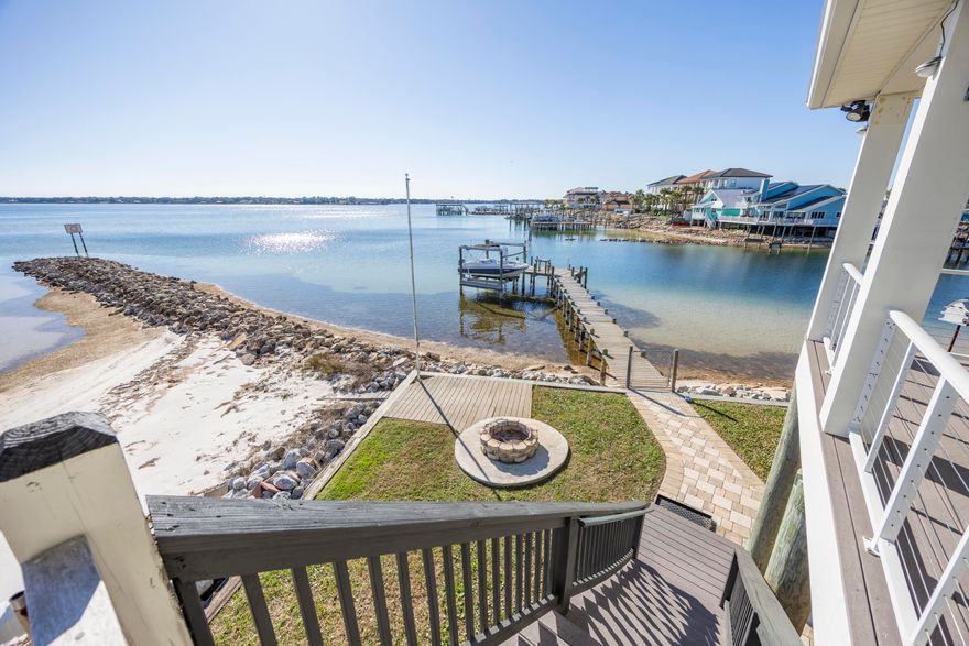Rare opportunity to own a true waterfront retreat with a private beach, private dock, and jetty--not just waterfront access.  Dock includes a fully operational boat lift and 240V electrical service that was added in 2023.  This 3bed/2 bath home has been thoughtfully and extensively updated since purchase. The kitchen features new stainless steel KitchenAid appliances, a remodeled pantry with doors and soft-close expandable shelving, an in-wall microwave/oven combo, and a newly installed hood over the range.  Bedrooms feature new LVP flooring, and the primary suite offers dual closets with custom built-ins. Bathrooms have upgraded lighting and fixtures, and the primary jacuzzi tub is fully functional with new motor and components.  Additional interior upgrades include a designer dining room light fixture imported from Europe and a custom built-in entertainment center in the living room.  Outdoor living has been completely transformed. The front yard was fully remodeled with desert-style landscaping, white pebble accents, new mailbox and front pillars, and a newly constructed cement wall.  In the backyard, repairs were made to walkways, and a permanent cement block firepit was added.  HVAC system replaced August 2025.  Seller may include an 18' Hurricane deck boat with 150HP Yamaha outboard and trailer, offered as-is, or sell separately.  This property blends modern updates, outdoor living, and premier waterfront amenitiesan ideal primary residence, vacation home, or investment opportunity.