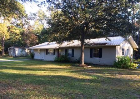 Good block home with a metal roof on over .5 acres! This home sits on a beautiful lot with several fruit trees. Located just a few blocks from Black Creek. Three bedrooms, one bath, nice sized kitchen, living room and dining area. The laundry room is located off the master bedroom. Laminateq and tile floors. The lot is all fenced in.