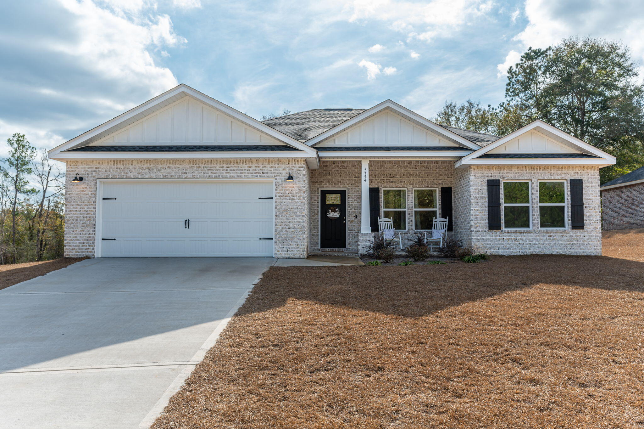 This beautiful four-bedroom home is nestled on .74-acre lot in Crestview. The all-brick construction showcases quality craftsmanship, while an inviting front and back porches create perfect spots for outdoor relaxation. Inside, the open floor plan features elevated ceilings with recessed lighting, creating an airy atmosphere throughout the home. The kitchen shines with quartz countertops, white shaker cabinets, stainless steel appliances, and an island with bar seating. The primary bedroom suite offers double vanities, tiled shower, and a walk-in closet. Additional bedrooms boast spacious closets, while luxury vinyl plank flooring flows through common areas. Enjoy community amenities including a playground and pool. The landscaped yard features a sprinkler system for easy maintenance.