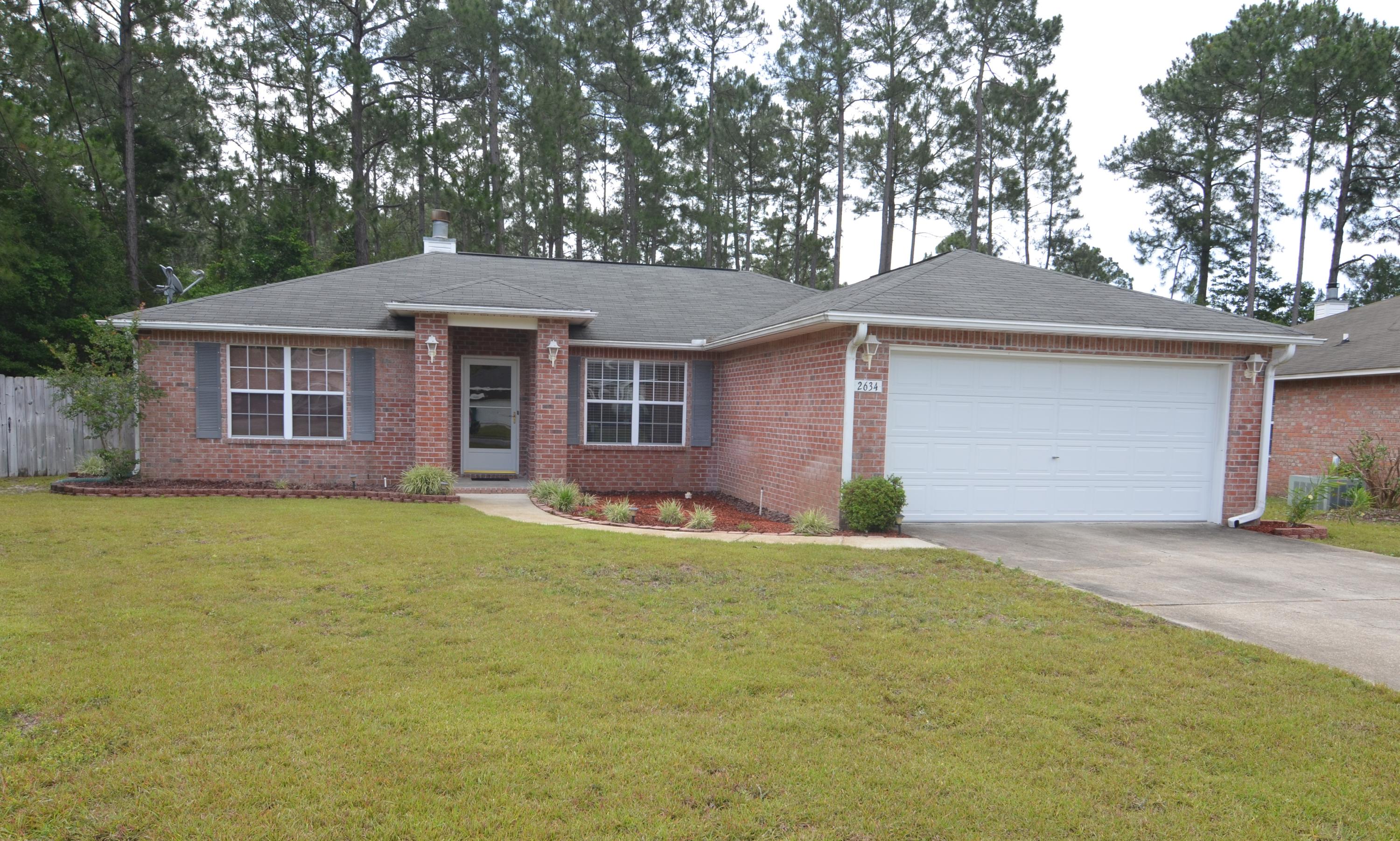 REDUCED $6000. Centrally located home close to Hurlburt Field and Navarre Beach! This ALL BRICK 3 Bedroom, 2 Bath home is located in a quiet and hidden neighborhood just off Hwy 399. Home features split bedrooms. Master Bdrm, Master Bath and additional bedroom recently painted. The Living Room features a vaulted ceiling and never been used fireplace. Large Master Bath includes 2 walk-in closets, separate shower, garden tub and dual vanities. The Kitchen has solid oak cabinets, tiled flooring and refrigerator. Large fenced in backyard with storage building, sprinkler system with well and pump and 2 car garage. New Hurricane Strength Garage door, Front door and fabric shutters. Buyer to verify all information important to buyer including but not limited to lot size, room sizes, zoning etc