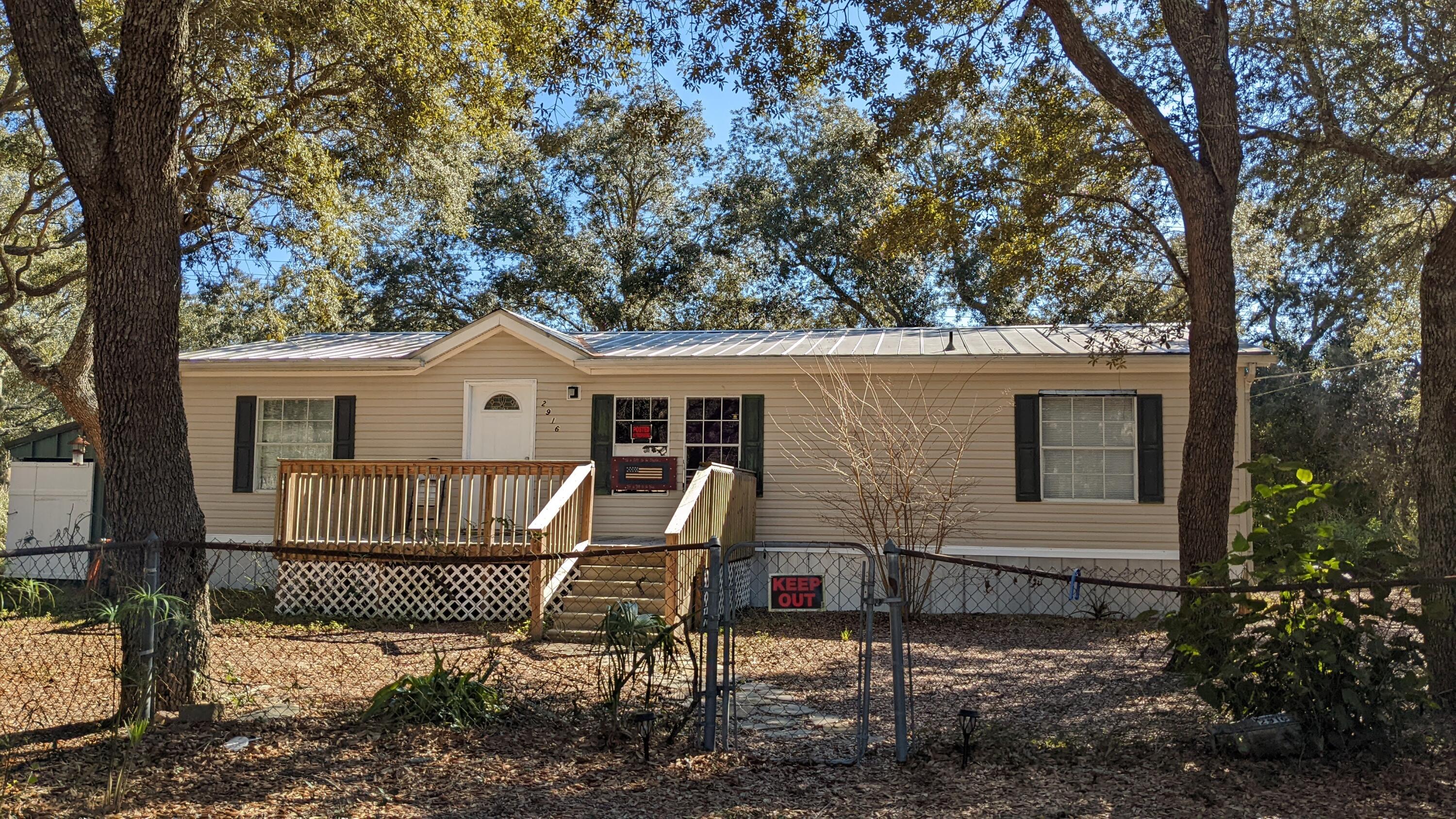 Great investment property. Metal roof with copper valley on double wide mobile home with split floor plan on approximately .3 of an acre. This home has laminate floors, wood burning fireplace. Master bath has a shower and large soaker tub.This home is located approximately 11 miles to Navarre Beach, approximately 18 miles to Hurlburt AFB.Sold as-is. Exclusions to sale: all furniture, trailer/RV/camper in back yard, swing set in front yard. Appliances are included, sold as-is.