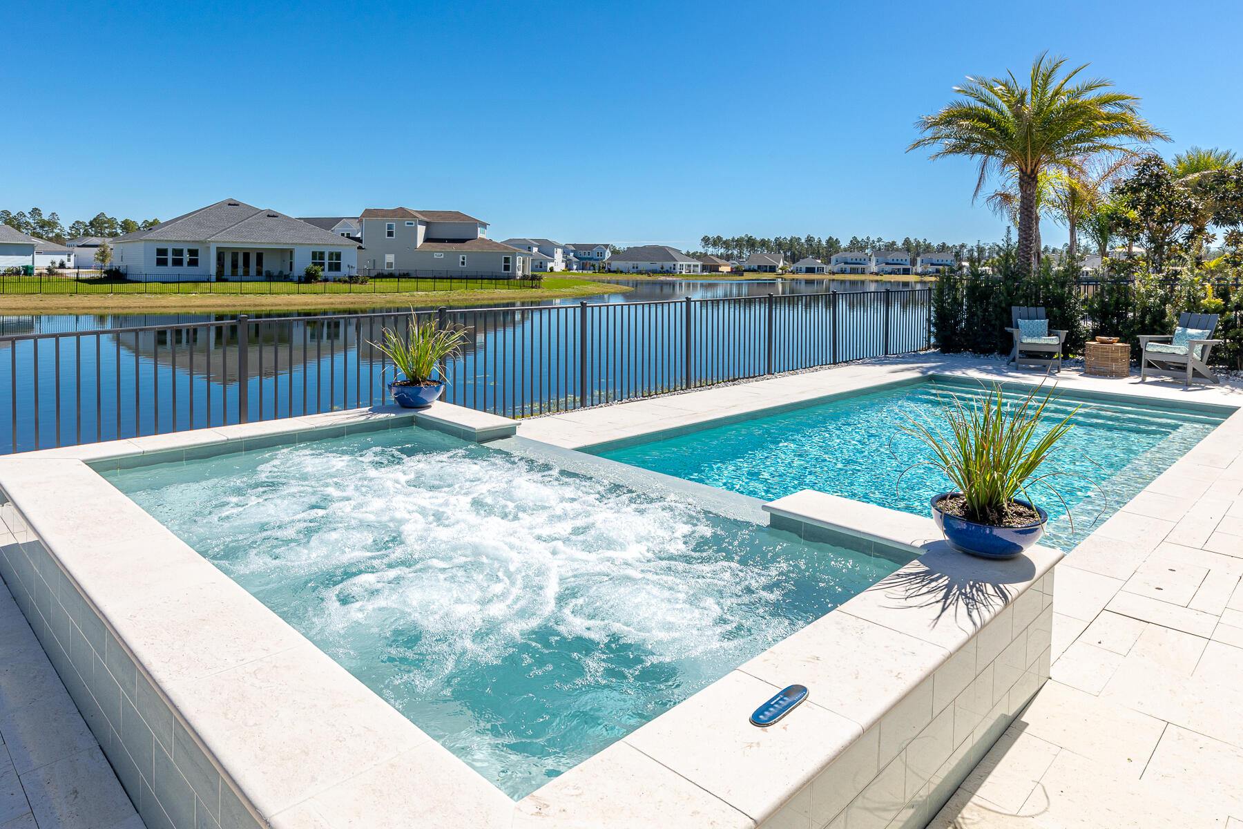 Perfectly situated on a premium lakeside lot inside the gates at Naturewalk Watersound Origins. Stunning 'Tampa' plan is the largest (4001 total sq ft - 2801 total living) Single level built in NW community. This pristine home has an abuidance of upgrades including beautiful hardwood flooring, shiplap accent walls,10 foot celings, georgeous designer lighting, electric fireplace. Custom Shutters and window treatments. 4thBR being enjoyed as an offfice with sliding glass doors. Gourmet Kitchen w/ gas stovetop,wine refrig., soaring cabinetry with lit glass display shelving, oversized island with bar seating and pantry. Bring the outdoors in by sliding the 5 panel glass doors open to the spacious enclosed Lanai with automatic privacy screens that open to a huge spa and saltwater heated pool!