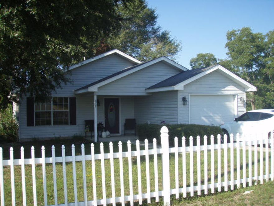 Immaculate home is ready for a new owner. This updated home would be great for first time home buyer or investor. Open floor plan with vaulted ceiling in living, dining and kitchen makes the home feel much larger than square footage indicates. Plentiful cabinets and counter space in large kitchen with breakfast bar and pantry. Nice size master bedroom with walk-in closet is separate from guest bedrooms. Master & guest bath offer a double vanity. Beautiful tile floors throughout the home. Covered entry porch, covered rear patio and large wood deck great for enjoying outdoor activities. Decorative vinyl fencing in the front yard and back yard is completely fenced and all abutting owners have privacy fence. Looking for a cute home with a white picket fence? This is it!