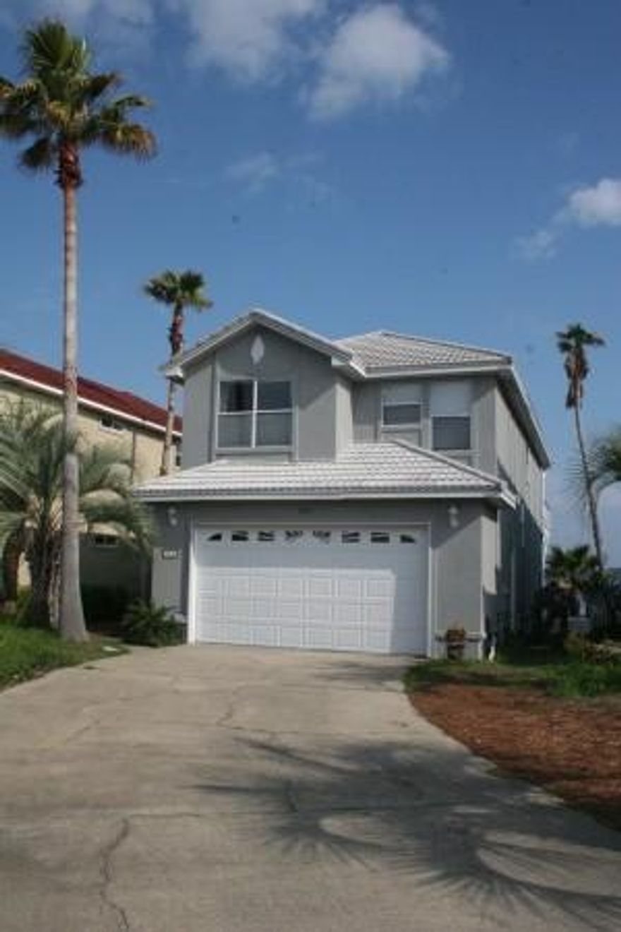 Stunning waterfront home with breathtaking water views of Garniers Bayou, situated in the gated community of Lighthouse Pointe. Freshly painted inside and out. Spacious and open living room with corner gas fireplace, custom lighting and tile flooring throughout. Dining room is designed perfectly to capture stunning water views during your dinner parties with family and guests. Designer kitchen with custom glass front display cabinets, including a built-in desk, wine rack and buffet. Corian counters with travertine backsplash and beautiful large granite breakfast bar and upgraded stainless steel appliances. The kitchen is open to the living room and dining room which, makes entertaining a breeze. Half bath conveniently located downstairs.