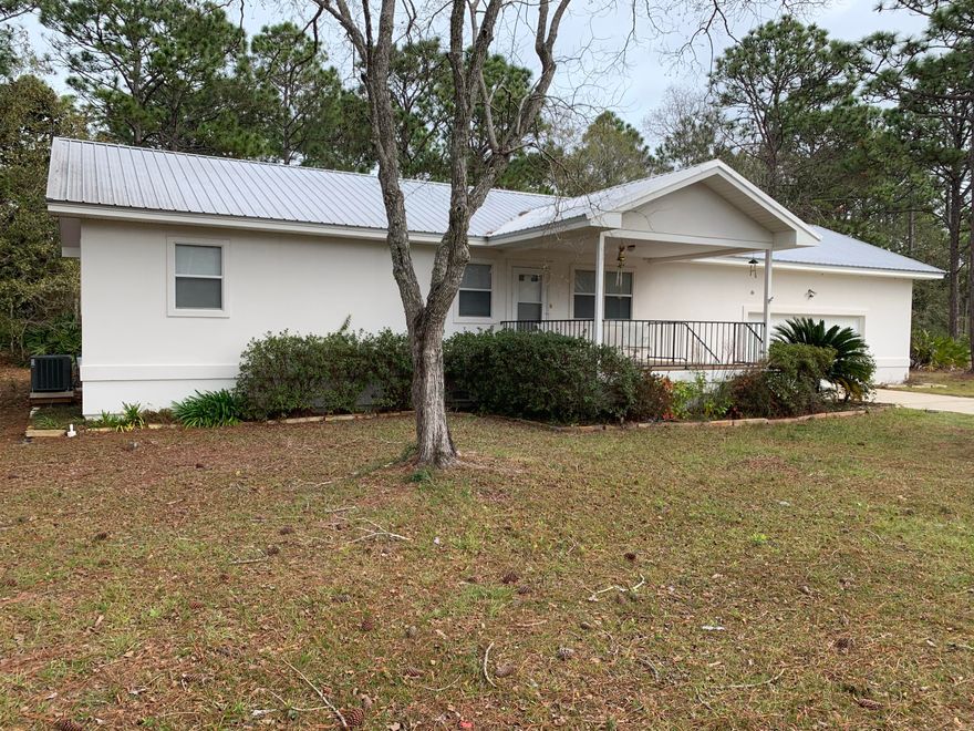 Adorable Florida cottage on .5+ acre lot, convenient to shopping, dining, beach and all amenities the area has to offer. The open floorplan is just right for modern living and opens to the large rear deck. The kitchen features all appliances, plenty of cabinet space and a picture window with views of the beautifully wooded back yard. The master bathroom suite offers a dressing area and a private shower area. The guest bedroom has plenty of natural light and access to the additional full bathroom from the hallway. Luxury vinyl flooring and tile flow throughout. Septic and well water means no water bill! Fresh paint throughout! The two car garage, with high ceilings is ideal for storage space. Both the front and back patio decks are equally spacious.