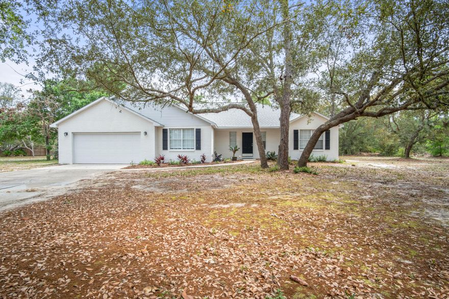 Completely renovated from roof to flooring and everything in between, this home feels brand new. From the wood grain tile floors, to the elegant granite countertops, the stainless appliances to the upgraded fixtures throughout, all finishes have been carefully selected to provide a fresh and modern feel. The split floorplan offers an exquisite master suite with double doors leading into the spa like master bathroom that brings a whole new meaning to 'his and hers.' The walk in shower is cleverly designed with two separate benches, tiled walls with mosaic tile accents, and a natural stone floor. Off to