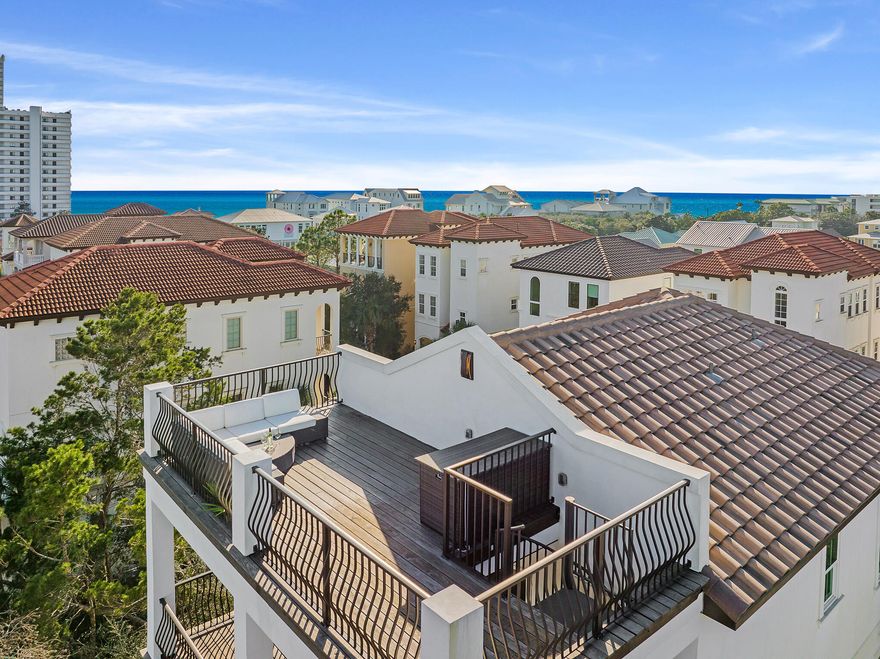 This stunning newly constructed residence located behind the private gates of  Palmeira Villas takes full advantage of the surrounding topography while showcasing the masterfully planned indoor and outdoor living space. Designed by architect Eric Craig and built by the renowned team at Kirby Construction Company, the open floor plan features nearly 2,600 square feet of thoughtfully designed living space. Upon entering the front door, you are greeted with a tasteful color palette with hardwood accents, 12' ceilings, an elevator, and two master suites.The second level living area is flooded with natural light boasting soaring coffered ceilings and a wet bar. The chef's kitchen encompasses ample cabinet space, an oversized island, a gorgeous backsplash, and a professional appliance suite.