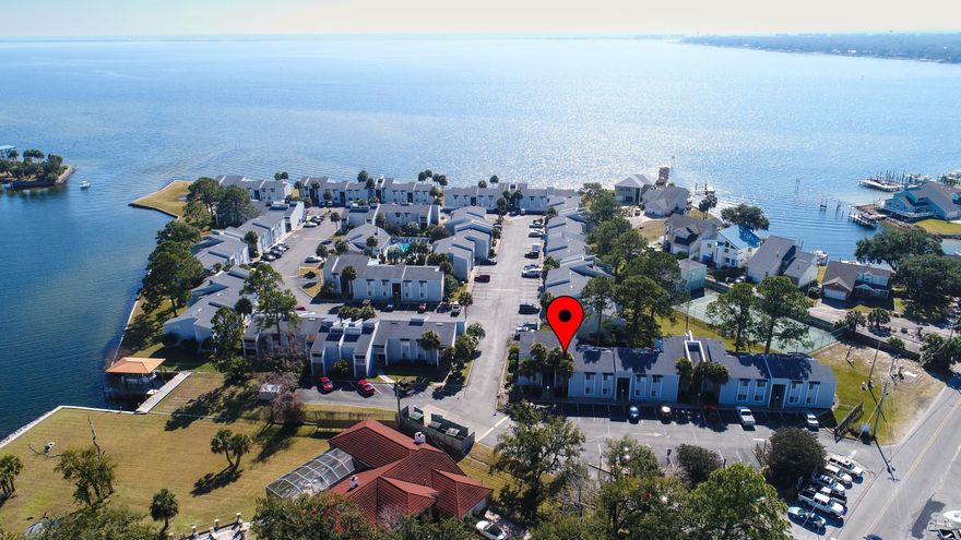 Finisterra Condominium is a gated community located on the Choctawhatchee Bay in Shalimar, Florida.  This waterfront community is made up of 148 one and two bedroom units on acres of waterfront property with amazing views of the bay. On-site amenities include a pool, lighted tennis court, sauna, laundry facilities, a clubhouse, and kayak put in. Right across the street is the Two Georges Marina where you can rent space to store your boat for those summer day boat rides to Crab Island and the Destin Harbor. This unit stands out with its vaulted ceilings and days old fresh paint throughout the entire condo. The fixtures in the kitchen and dining room are all new, along with a brand new ceiling fan. The refrigerator and microwave have also recently been replaced.