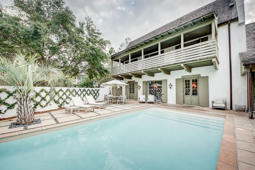 A BOBBY MCALPINE designed CONCRETE home is on ONE OF THE LARGEST LOTS in ROSEMARY BEACH w/ NEW CARRIAGE HOUSE, private COURTYARD & oversized POOL. Open Concept living/dining/kitchen area on the 1st floor w/ plush white seating & neutral color palette, shiplap walls & ceiling, & vistas out to the courtyard & pool. The den is offset w/ large fireplace for a perfect gathering area. Large breakfast bar & additional dining space w/ oversized seating to accommodate the whole family. The main kitchen features double Viking stove & range, backsplash spanning the back wall & large island/breakfast bar. The additional Scullery off of Kitchen offers ample storage, open shelving, double Sub Zero refrigerators, built in microwave & additional counter space. The 1st Floor Master Suite opens onto the