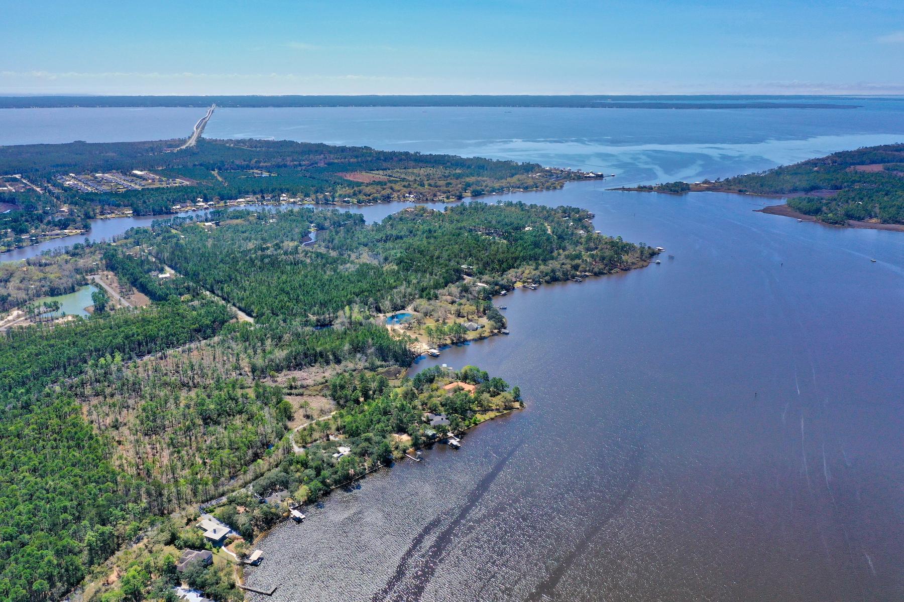Magnificent stretch of seven acres located on peaceful Lagrange Bayou in Freeport, Florida. This one story sprawling ranch home resides on 400 feet of waterfront on Holly Point itself. An option to purchase an adjacent fifteen acres is also available. Enjoy panoramic views from a multitude of vantage points in this wing shaped one story floor plan. A long gravel driveway traverses three acres towards a welcoming circular drive. Built in 2002, this home offers many modern conveniences providing areas to entertain. The spacious open kitchen living floor plan includes a separate dining room, library and lengthy gallery corridors. The large master bedroom wing offers high ceilings, fireplace, wet bar, and sizable master bath with separate vanities.