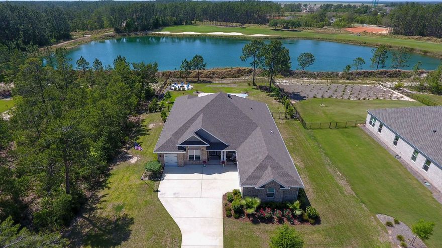 Welcome to this beautifully designed 2020-built home situated on a .59 acre premium golf course lot with peaceful water views and a spacious fenced backyard. Offering the perfect blend of luxury and functionality, this property is built for both comfort and entertaining. Enjoy ample parking with a two-car garage plus a separate golf cart garage — all with epoxy flooring — and a nearly new 2024 six-seater golf cart included. Additional upgrades such as a tornado shelter and reverse osmosis system. The private backyard retreat is a showstopper featuring a screened porch, fire pit, putt-putt area, and a 15x25 gunite sports pool with heating and cooling, tanning ledge, bubblers, and autofill. Inside, you'll find abundant natural light, hard surface flooring, raised ceilings, curved archways , and both formal and informal living and dining spaces anchored by a cozy fireplace. The chef's kitchen features white quartz countertops, a large island with breakfast bar, smooth surface range, and an oversized walk-in pantry. The primary suite includes a flexible bonus area ideal for a home office, nursery, or gym. Luxury, recreation, and thoughtful upgrades  all in one exceptional home. Windswept amenities include pickle ball, tennis, basketball, playground, pool and more!
Lot next door is available, it's .59 acre and allows for the privacy or create your own estate. $135k premium water view and golf course lot.