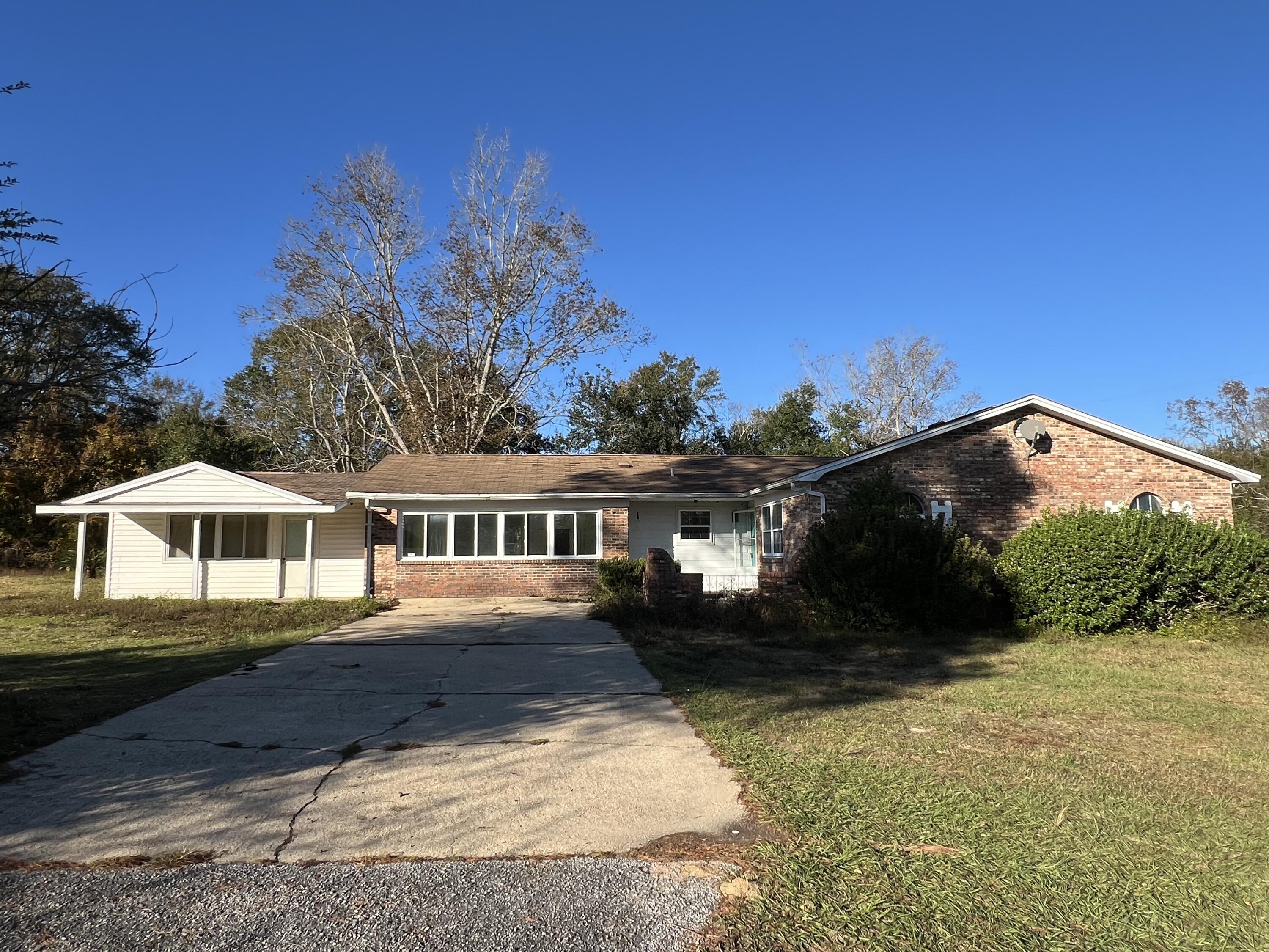 If you are looking for a getaway from the bustle of the city, this REO home just might be for you. Resting on over 3 acres of cleared level land, this 3 bedroom 2 bath brick home was built in 1968 and comes with tile in the main living areas, baths, and kitchen and carpeted bedrooms.  The property comes with a detached work shop that could easily be converted into a detached living space. Home does need repairs and will not qualify for most financing. Call today!